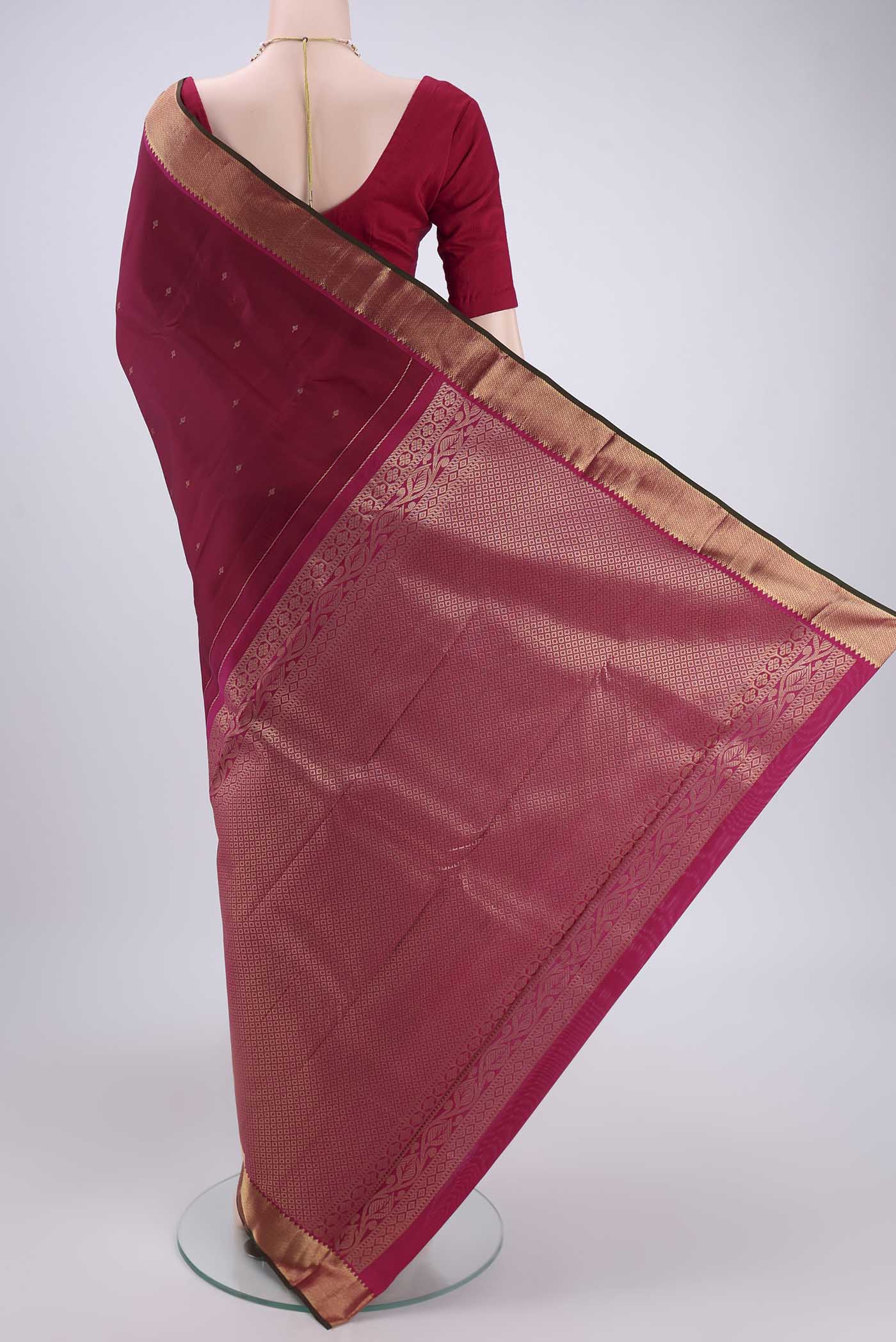 Flat view of Rust Kanjivaram Silk Saree with Zari Butta on the body and Zari Border. 