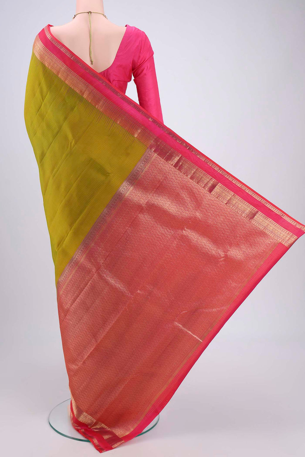 Flat view of Green Kanchipuram Silk Saree with Zari Butta on the body and Zari Border. 