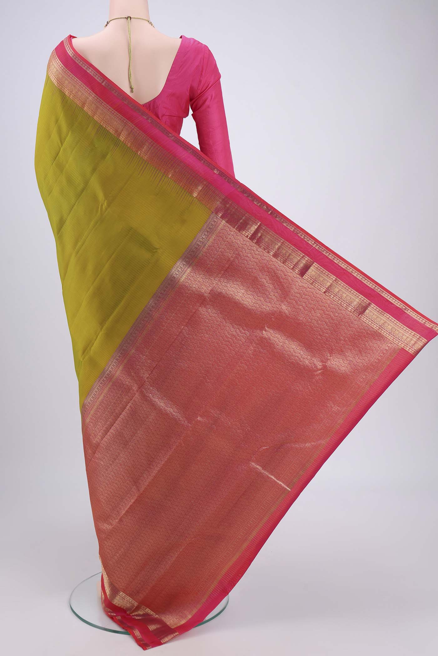 Flat view of Green Kanchipuram Silk Saree with Zari Butta on the body and Zari Border. 
