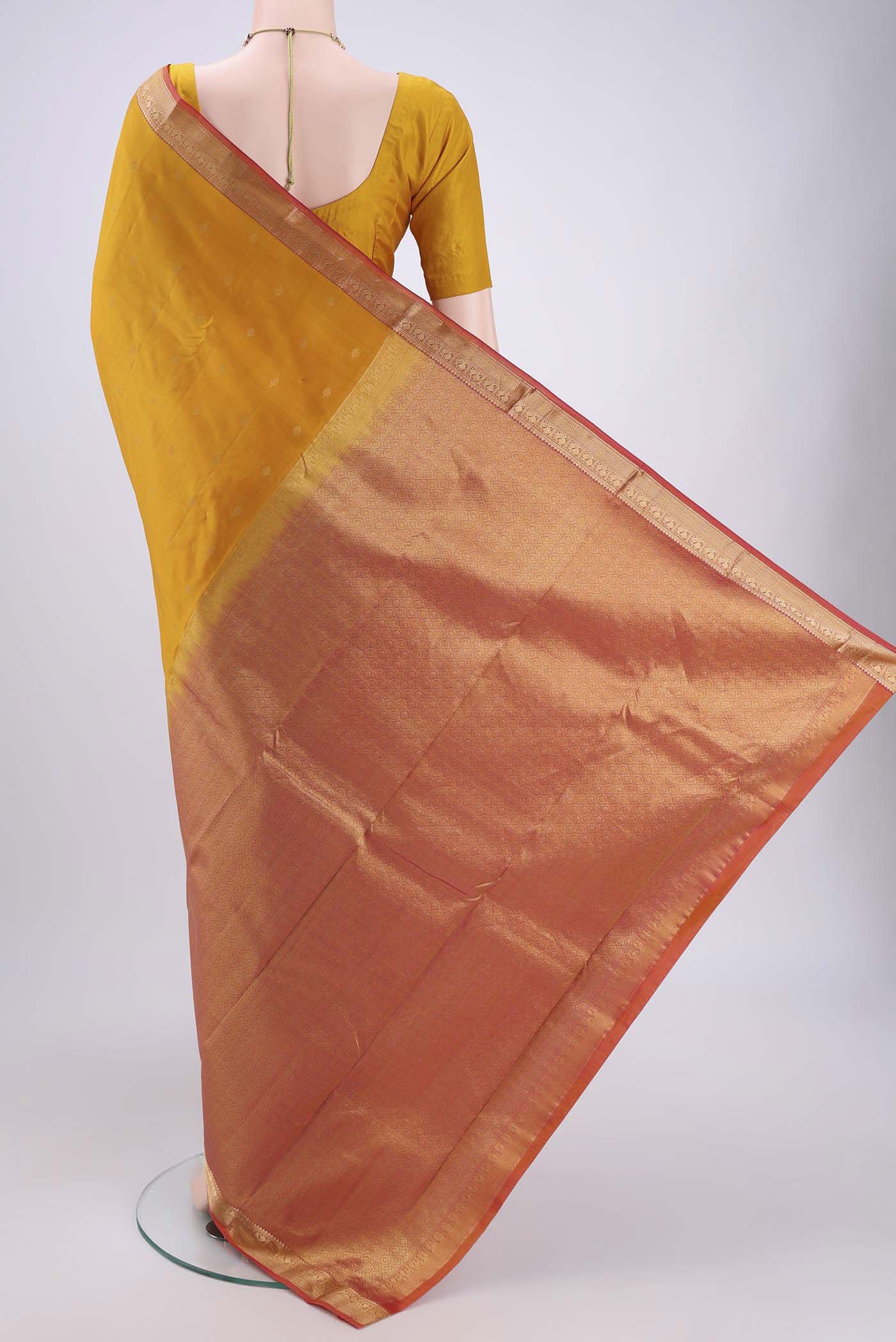 Flat view of Yellow Kanchipuram Silk Saree with Zari Butta on the body and Zari Border. 