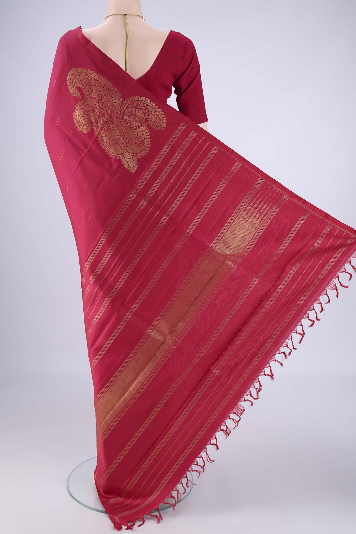 Flat view of Pure Silk Pure Zari Maroon Kanjivaram Saree with Zari Butta on the body and Without Border. 