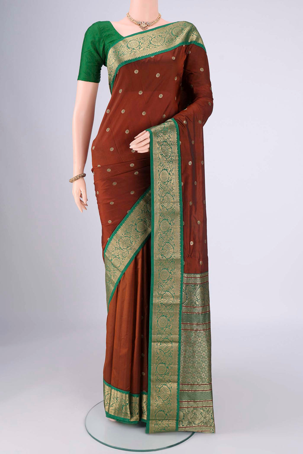 Brown Blended Bangalore Silk Saree with Zari And Thread Butta on the body and Zari Border.  displayed on a mannequin