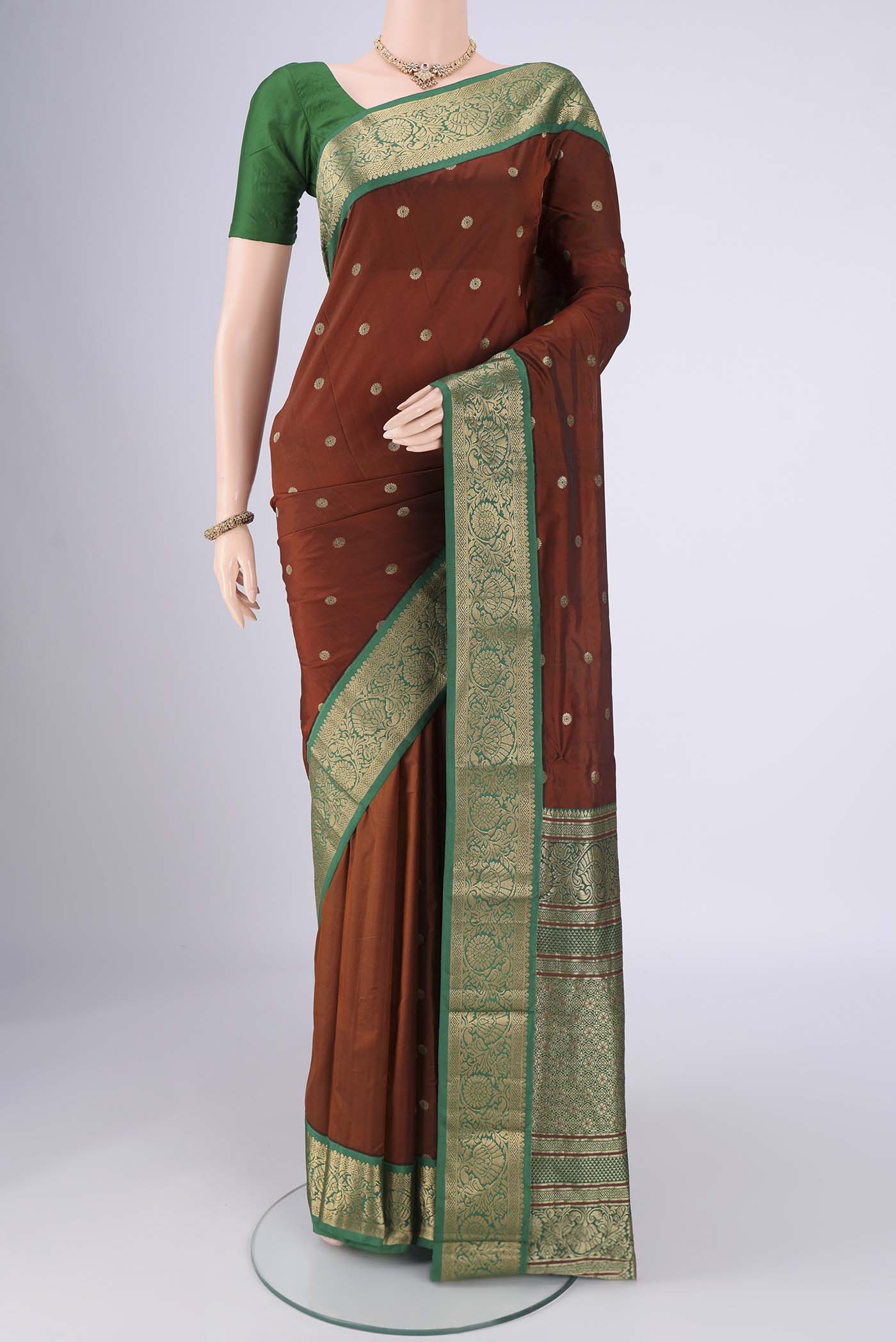 Brown Blended Bangalore Silk Saree with Zari And Thread Butta on the body and Zari Border.  displayed on a mannequin