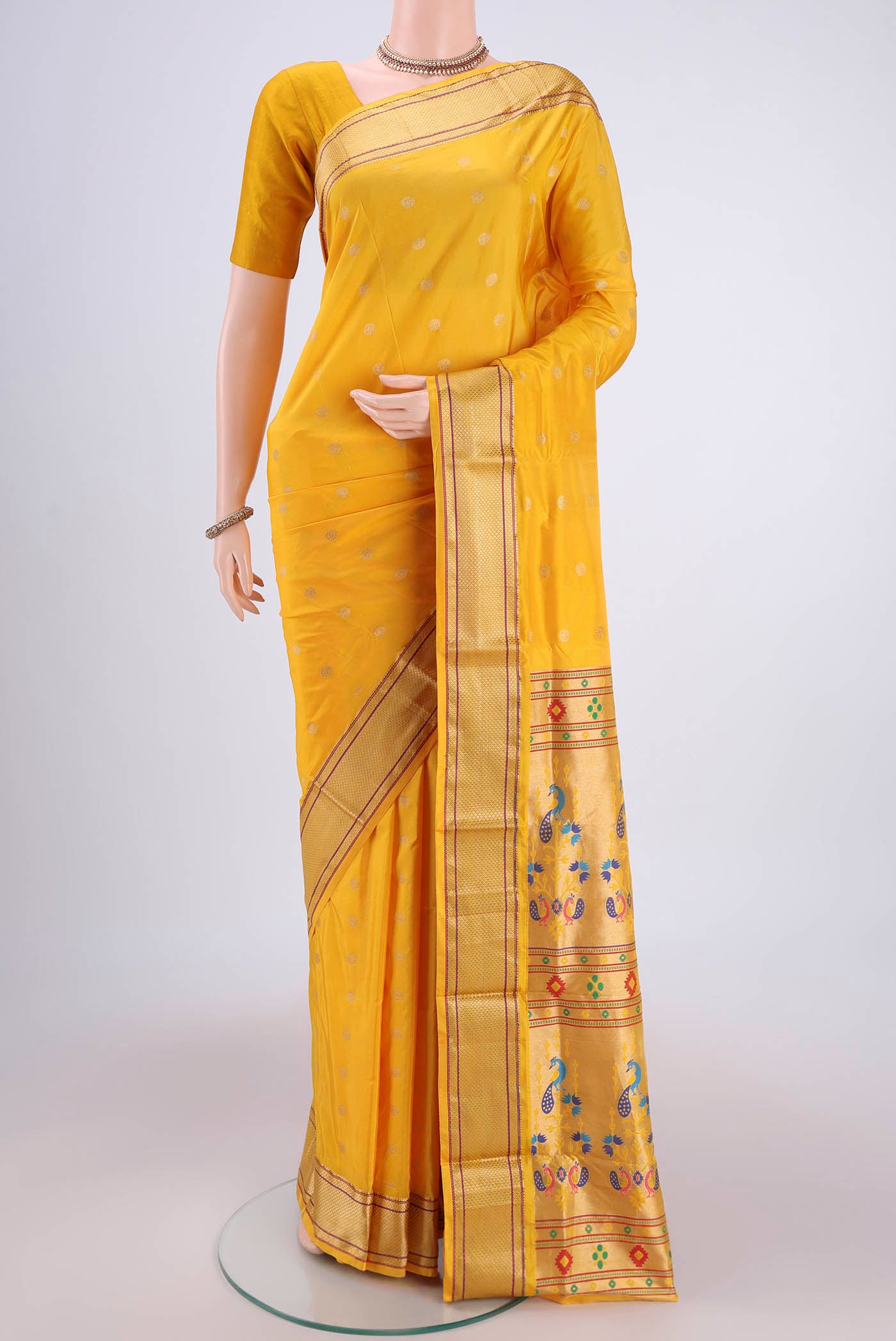 Yellow Blended Bangalore Silk Saree with Zari Butta on the body and Paithani Border.  displayed on a mannequin