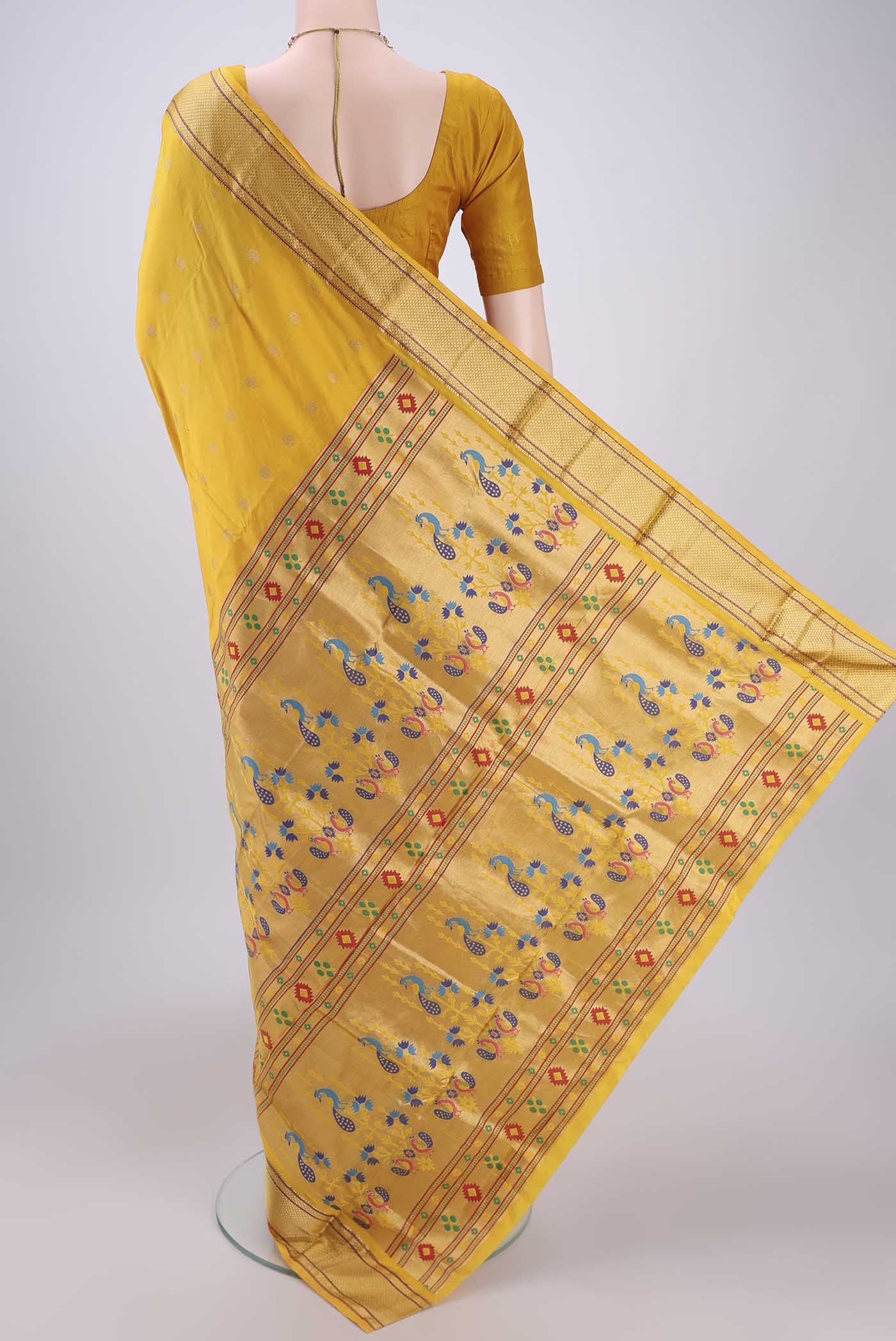 Flat view of Yellow Blended Bangalore Silk Saree with Zari Butta on the body and Paithani Border. 