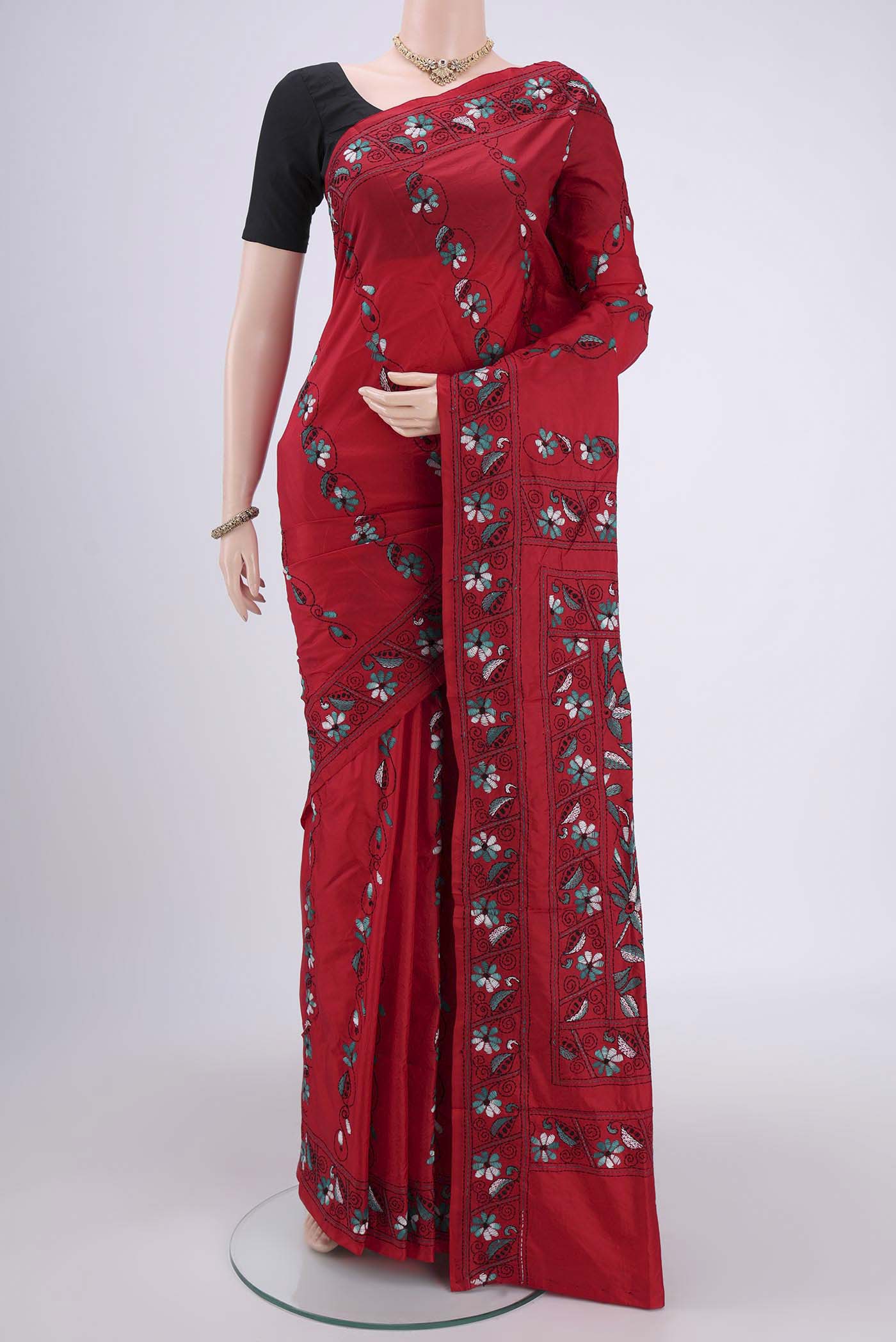 Red Tussar Silk Saree with Kantha Work on the body and Embroidery Border.  displayed on a mannequin