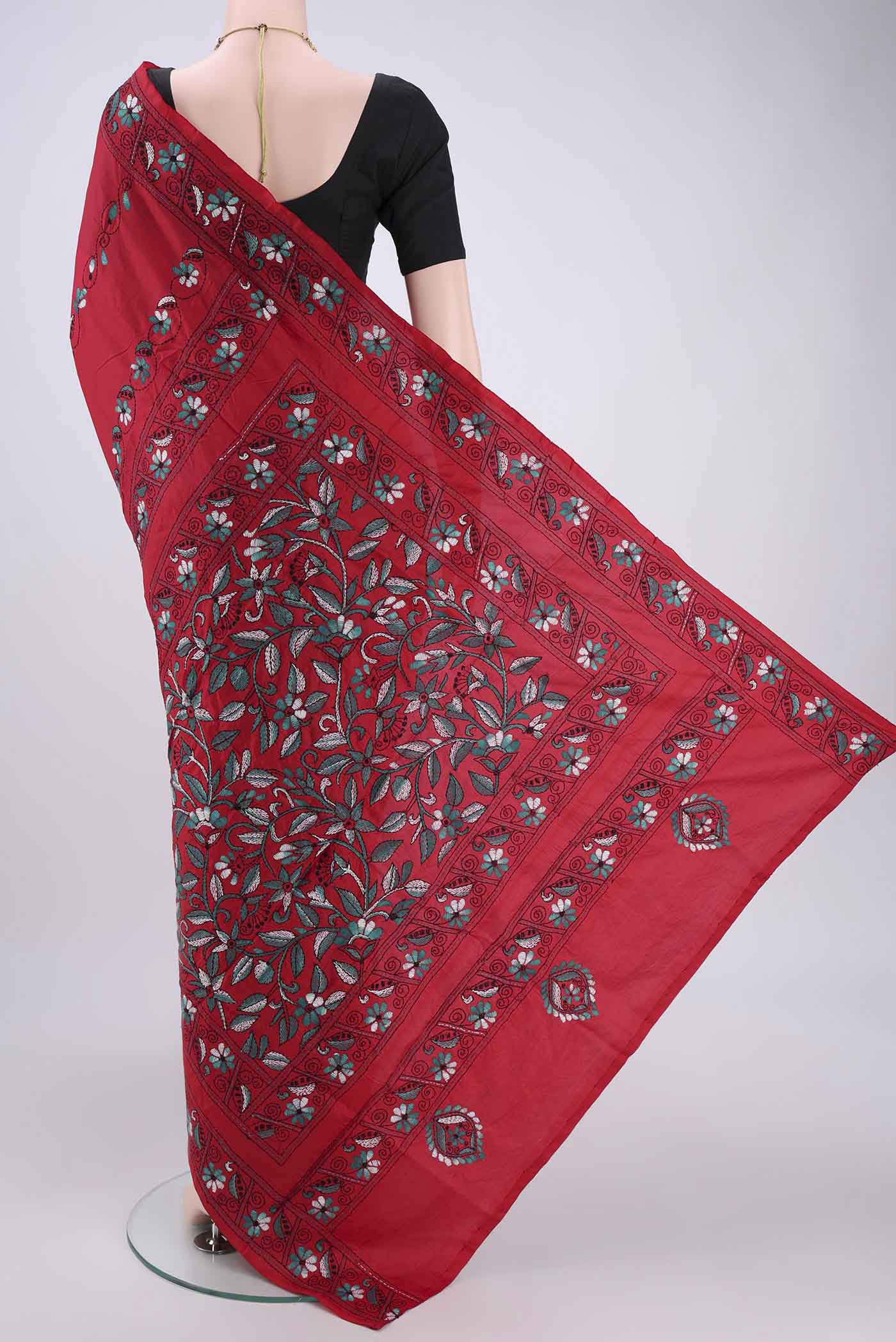 Flat view of Red Tussar Silk Saree with Kantha Work on the body and Embroidery Border. 