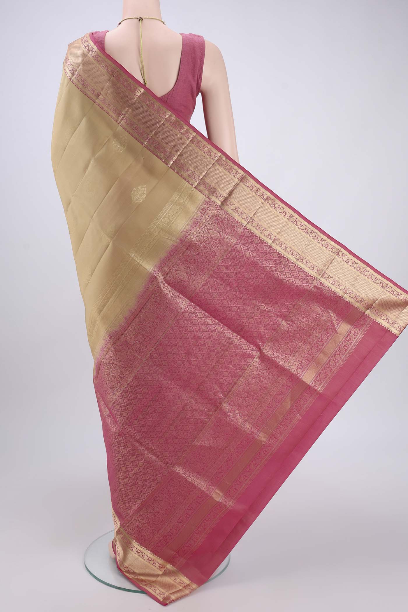 Flat view of Beige Soft Silk Saree with Zari Butta on the body and Zari Border. 