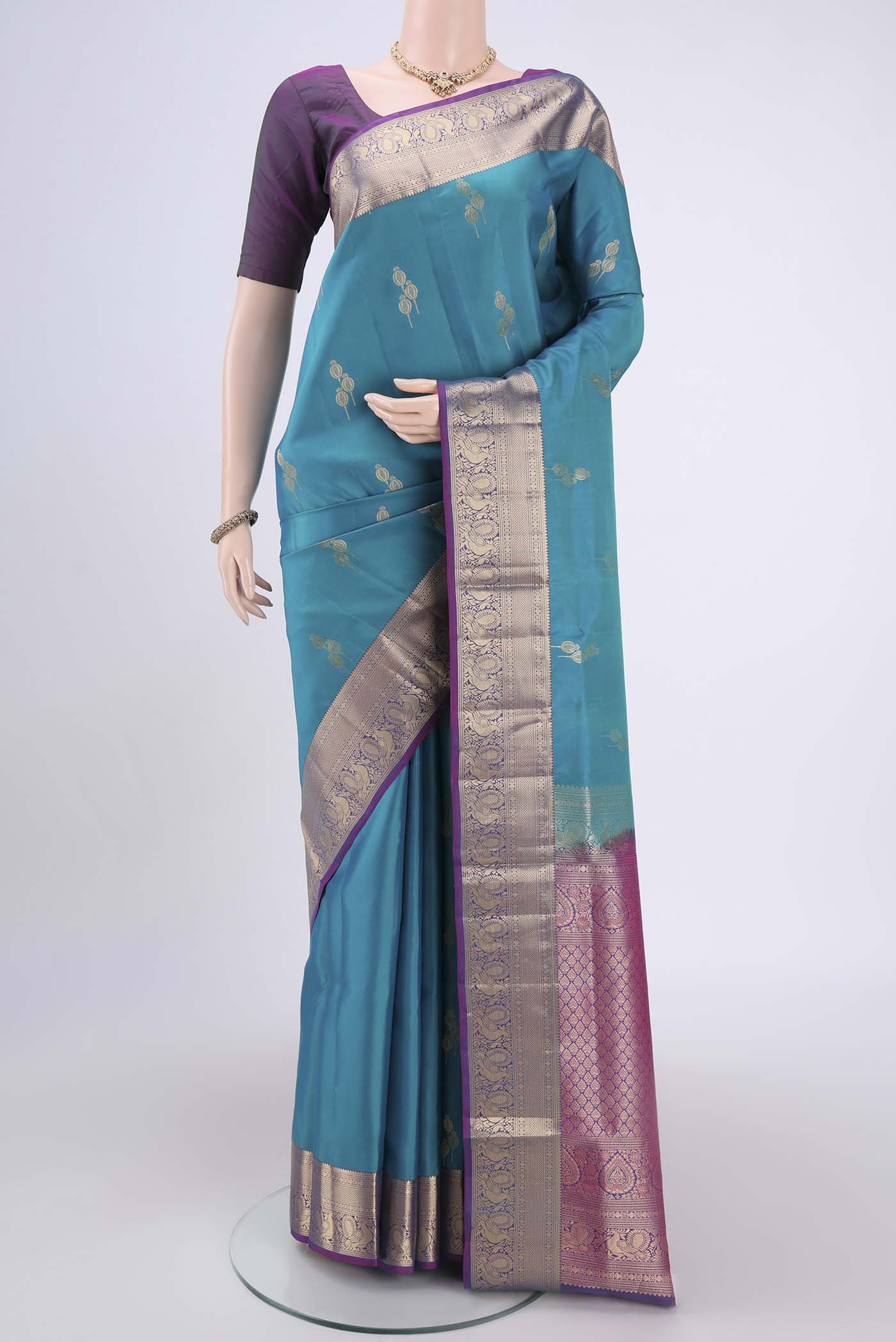 Blue Soft Silk Saree with Zari Butta on the body and Zari Border.  displayed on a mannequin