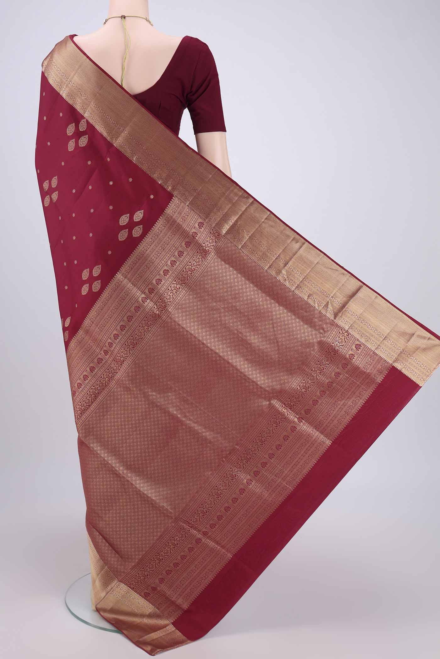 Flat view of Maroon Dual Tone Soft Silk Saree with Zari Butta on the body and Zari Border. 