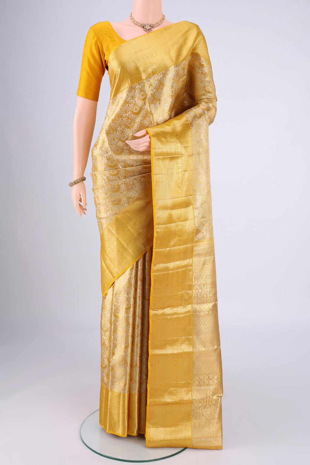 Lemon Yellow Dual Tone Kanjivaram Silk Saree with Zari Brocade on the body and Zari Border.  displayed on a mannequin