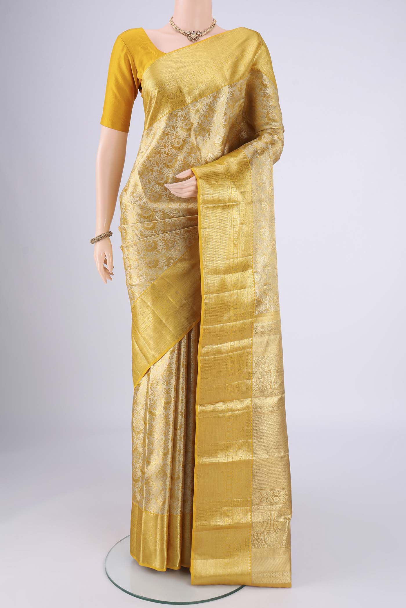 Lemon Yellow Dual Tone Kanjivaram Silk Saree with Zari Brocade on the body and Zari Border.  displayed on a mannequin