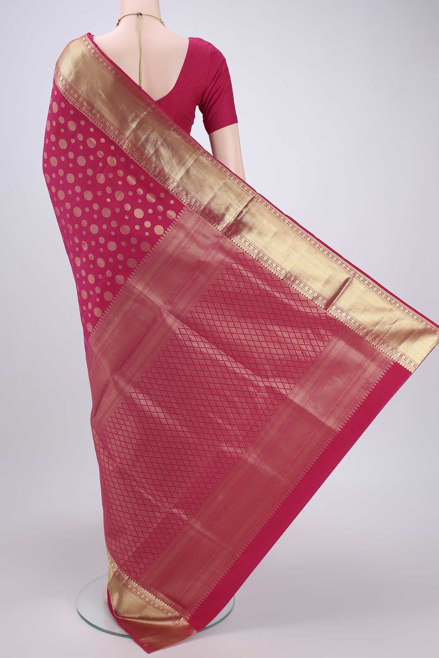 Flat view of Rani Pink Soft Silk Saree with Polka Dots on the body and Zari Border. 