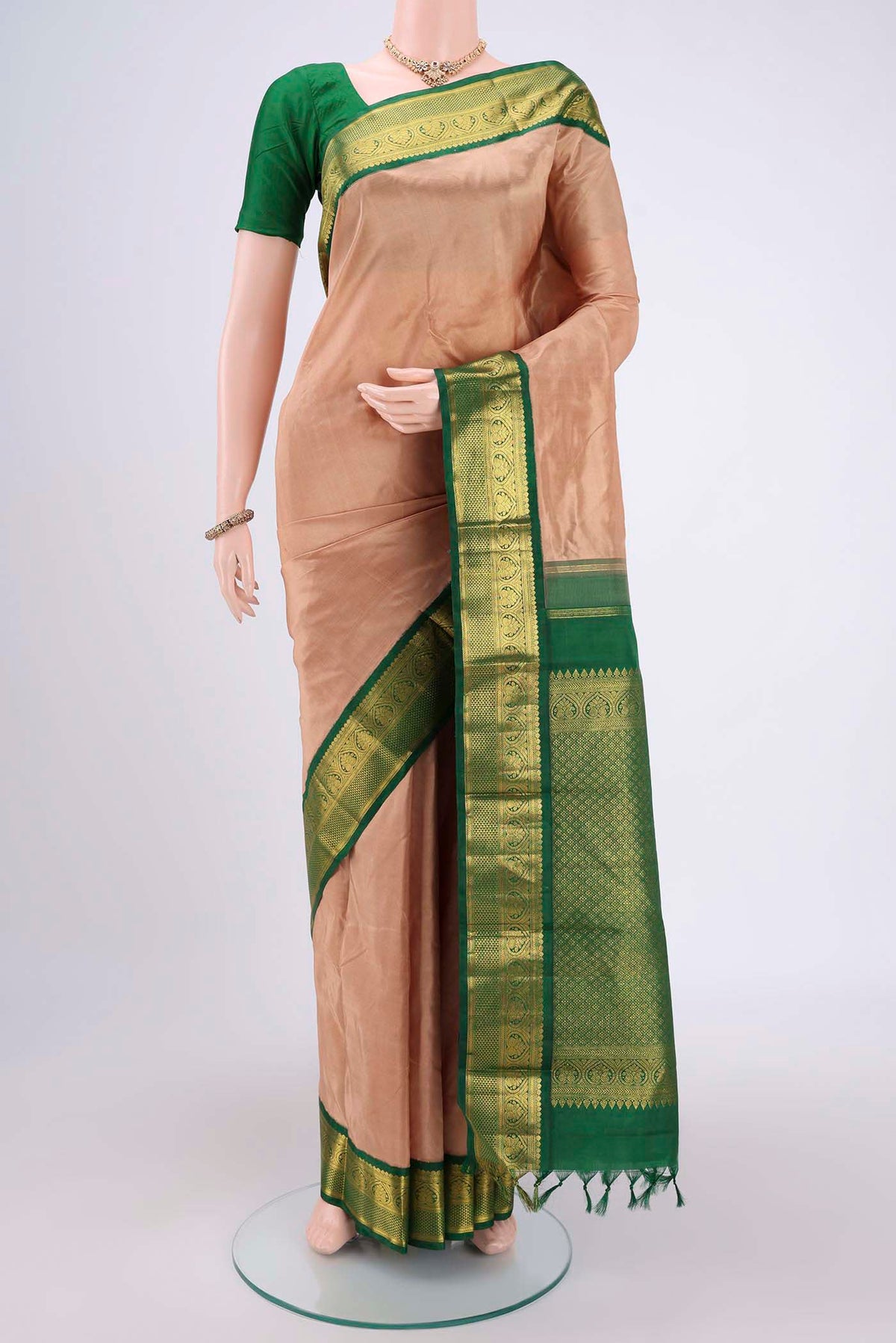 Beige Kanjivaram Silk Saree with Plain Body and Zari Border.  displayed on a mannequin