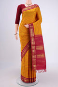 Mustard Kanchipuram Silk Saree with Veldhari on the body and Zari Border.  displayed on a mannequin