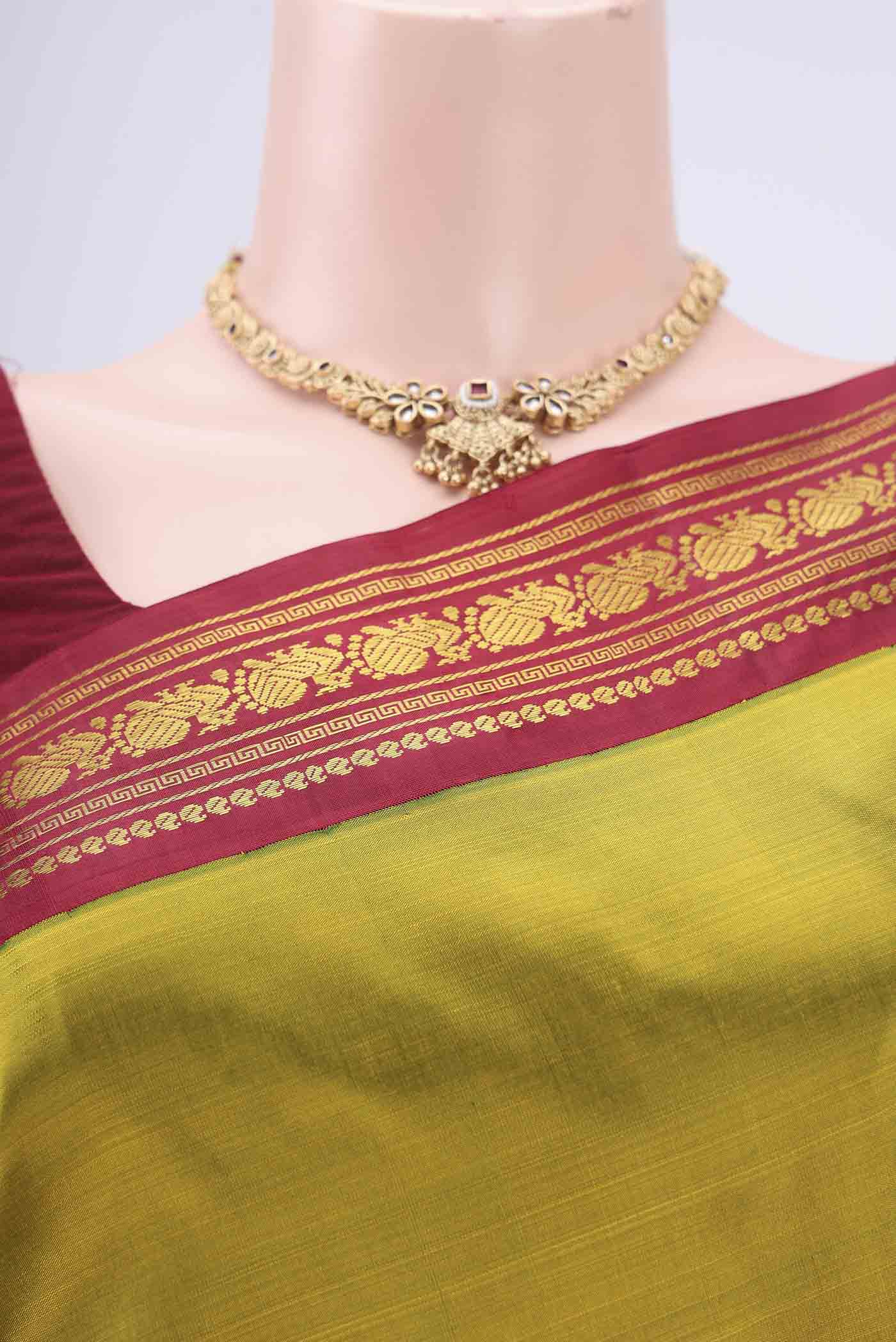 Border image of Mehandi Green Kanchipuram Saree with Plain Body and Zari Border. 