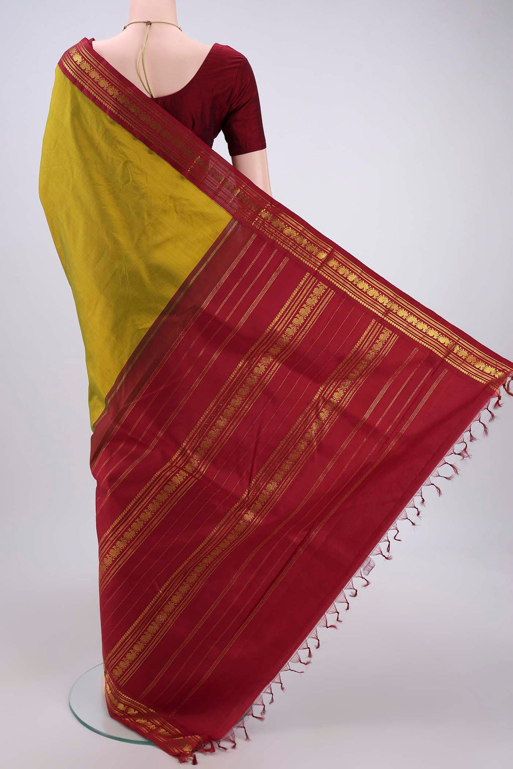 Flat view of Mehandi Green Kanchipuram Saree with Plain Body and Zari Border. 