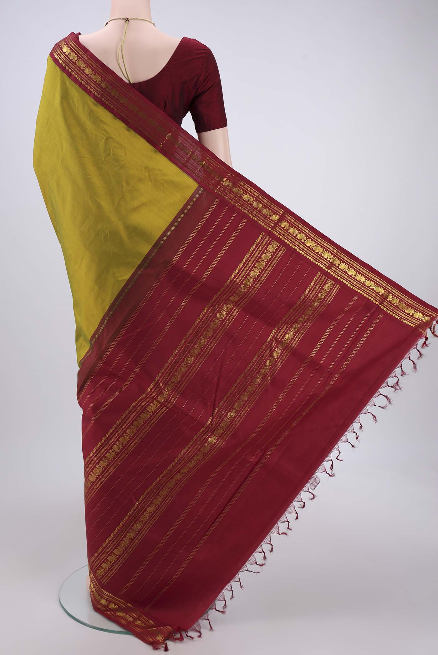 Flat view of Mehandi Green Kanchipuram Saree with Plain Body and Zari Border. 