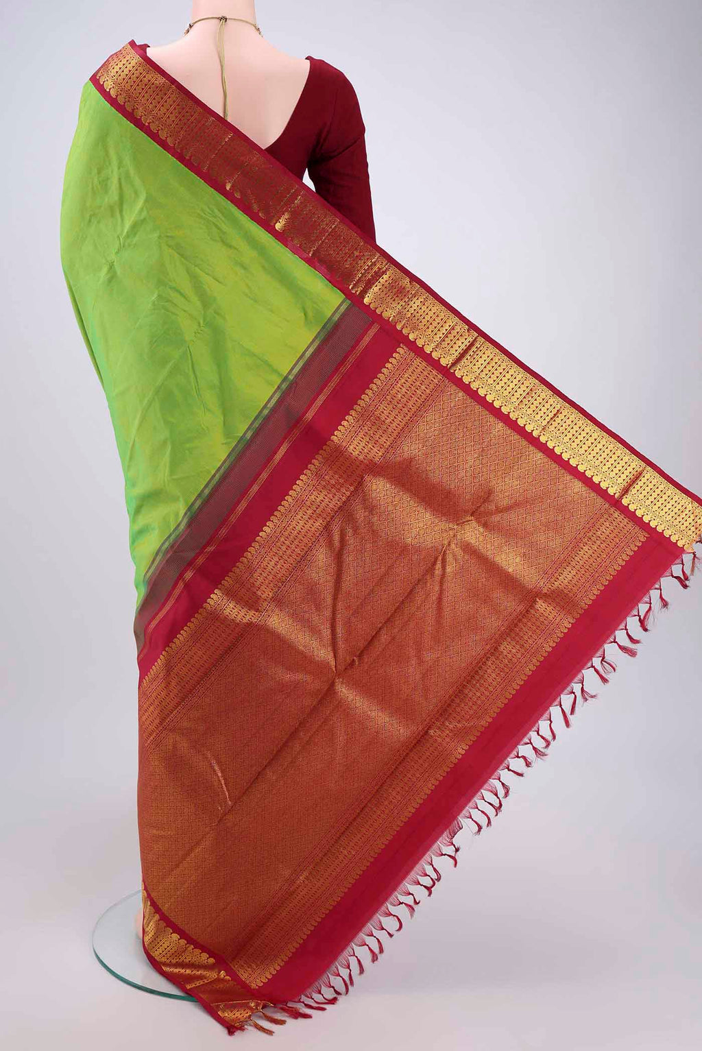 Flat view of Parrot Green Kanjivaram Silk Saree with Plain Body and Zari Border. 
