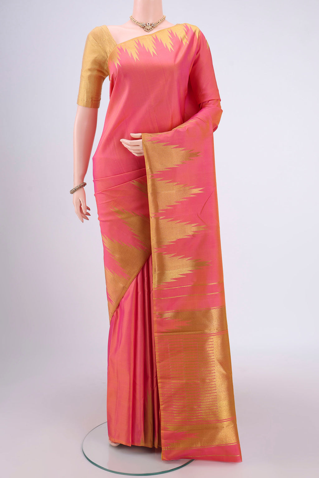 Pure Silk Pure Zari Pinkish Yellow Kanchipuram Saree with Zari Butta on the body and Zari Border.  displayed on a mannequin