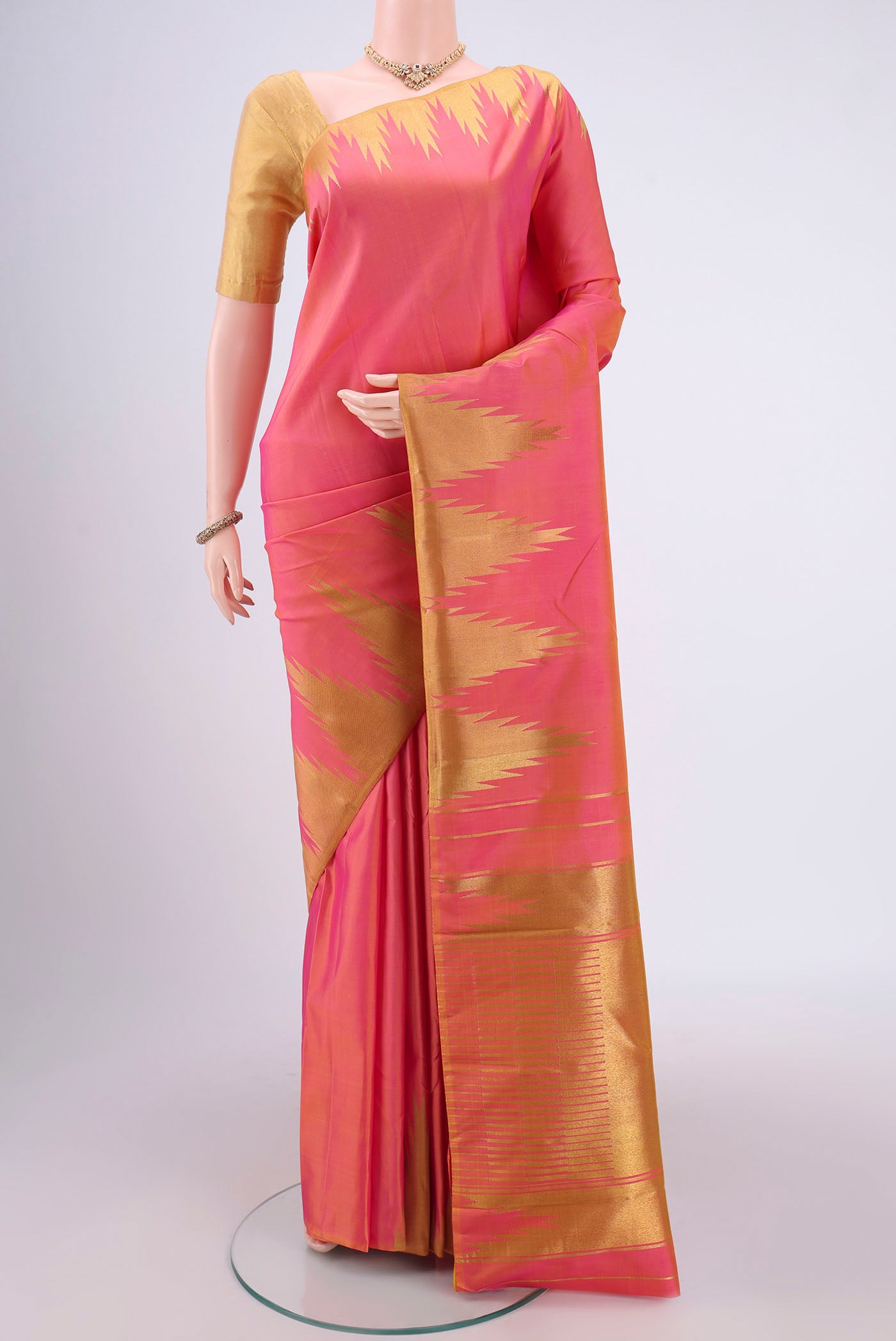 Pure Silk Pure Zari Pinkish Yellow Kanchipuram Saree with Zari Butta on the body and Zari Border.  displayed on a mannequin