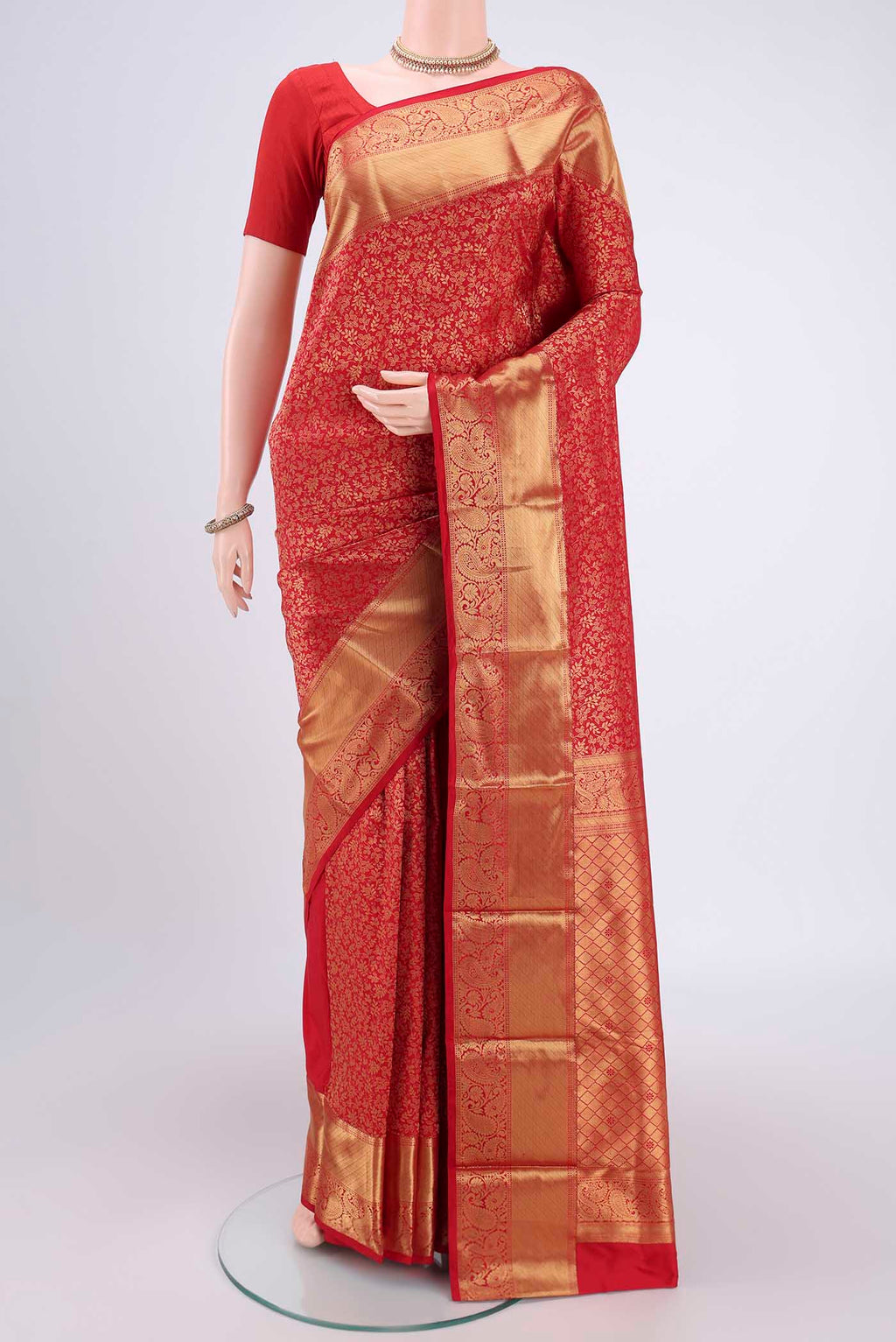Red Kanjivaram Silk Saree with Zari Butta on the body and Zari Border.  displayed on a mannequin