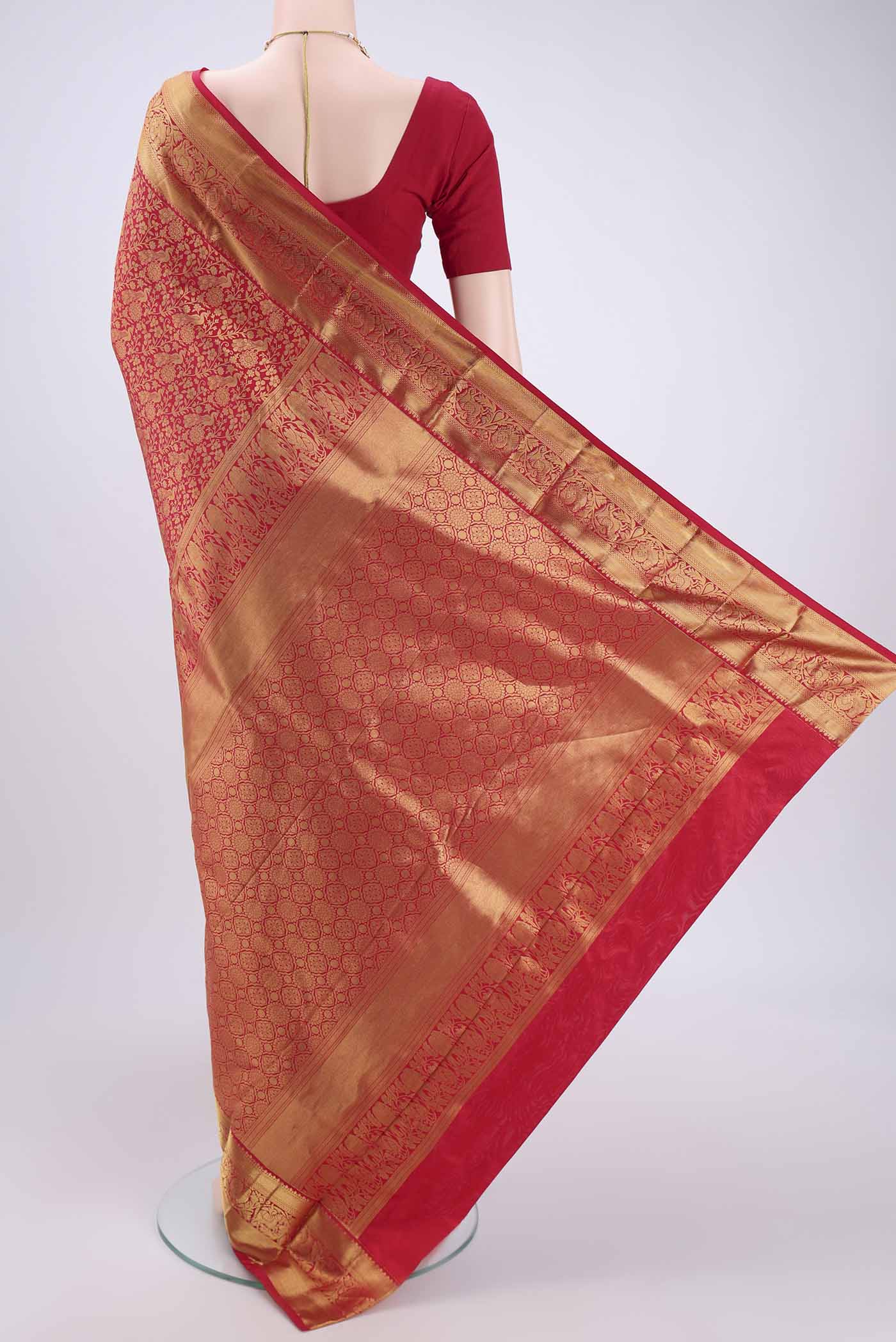Flat view of Red Kanjivaram Silk Saree with Zari Butta on the body and Zari Border. 
