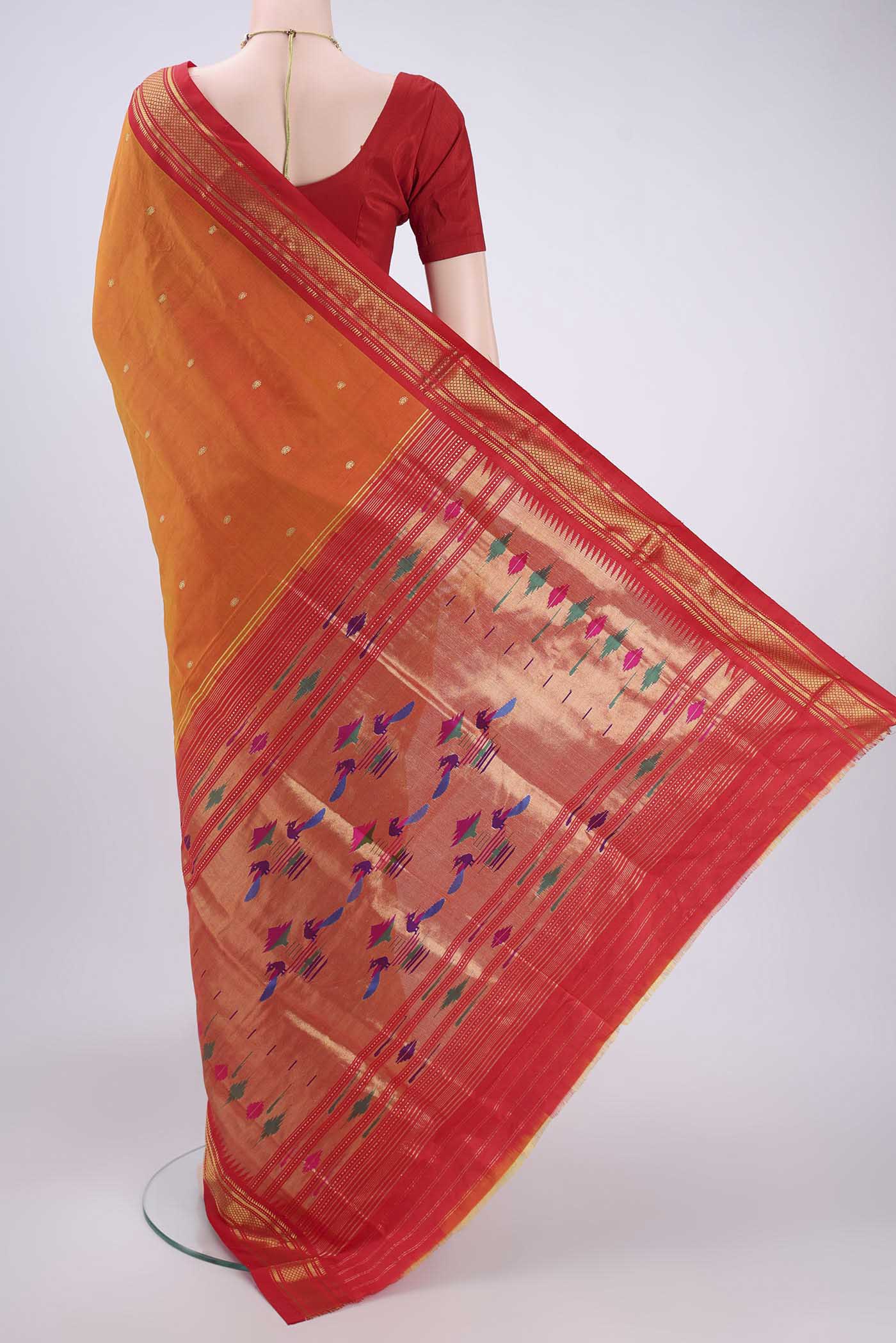 Flat view of Orange Paithani Silk Saree with Zari Butta on the body and Zari Border. 