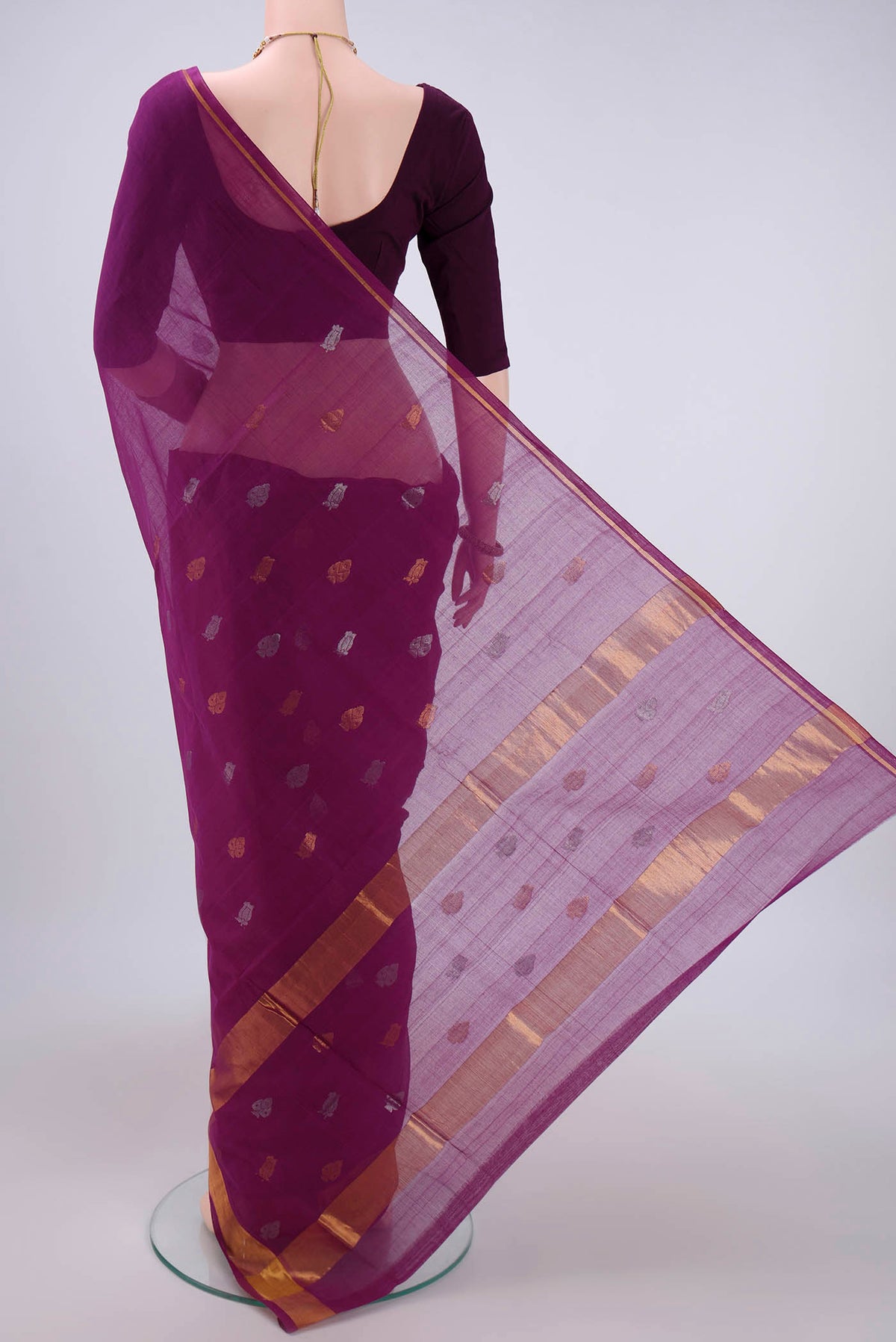 Flat view of Magenta Cotton Saree with Zari Butta on the body and Zari Border. 
