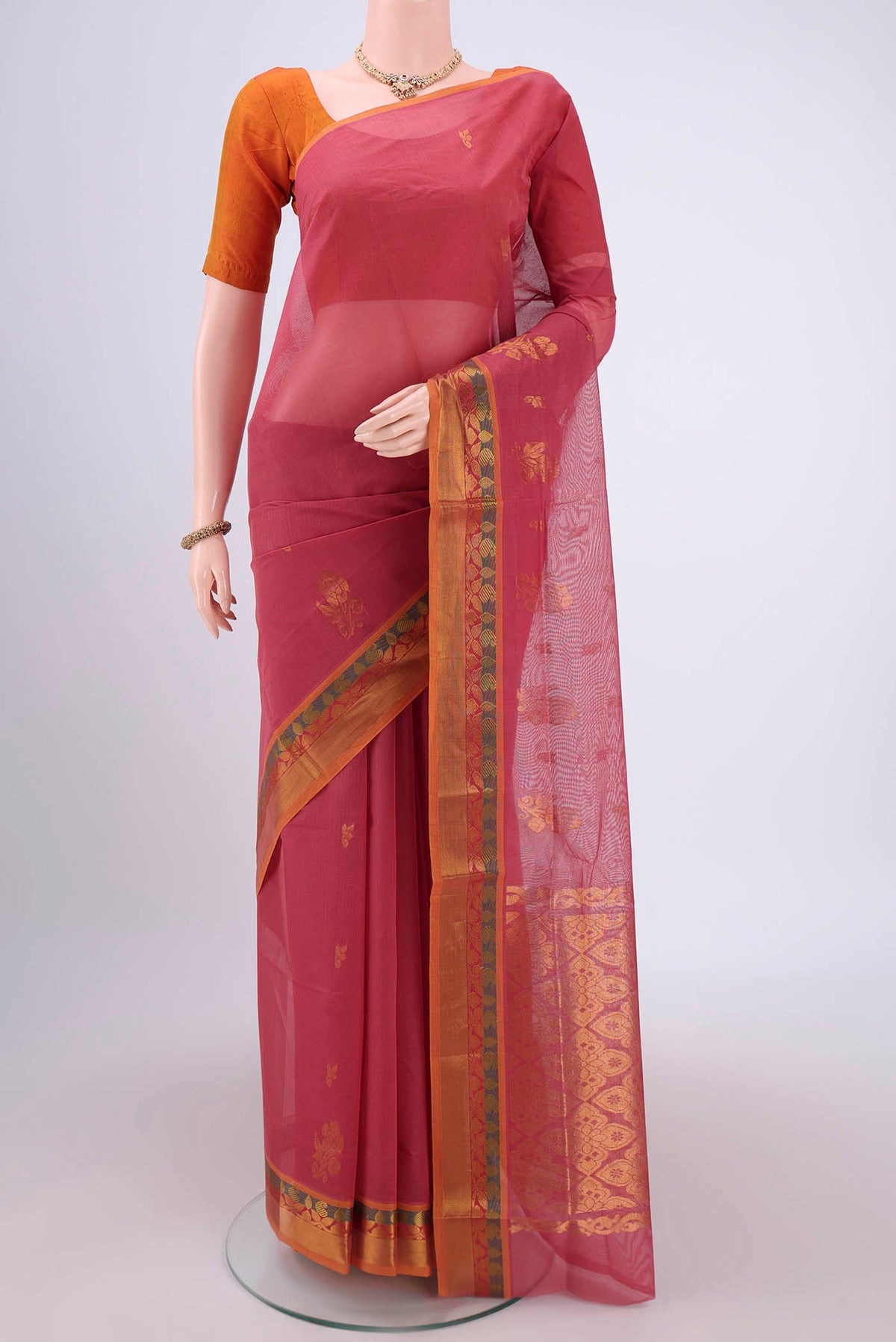 Light Magenta Venkatagiri Cotton Saree with Zari Butta on the body and Zari Border.  displayed on a mannequin