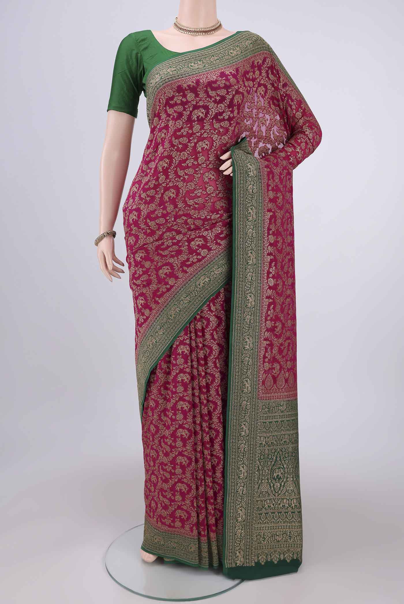 Rani Pink Banarasi Georgette Saree with Zari Brocade on the body and Zari Border.  displayed on a mannequin