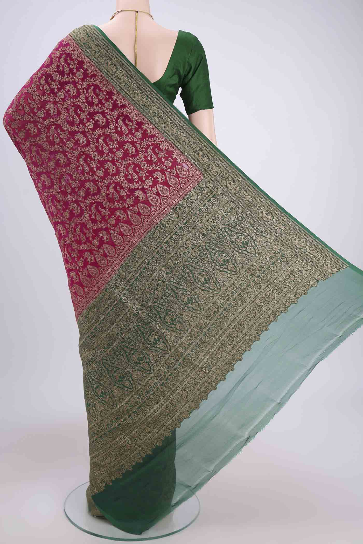 Flat view of Rani Pink Banarasi Georgette Saree with Zari Brocade on the body and Zari Border. 