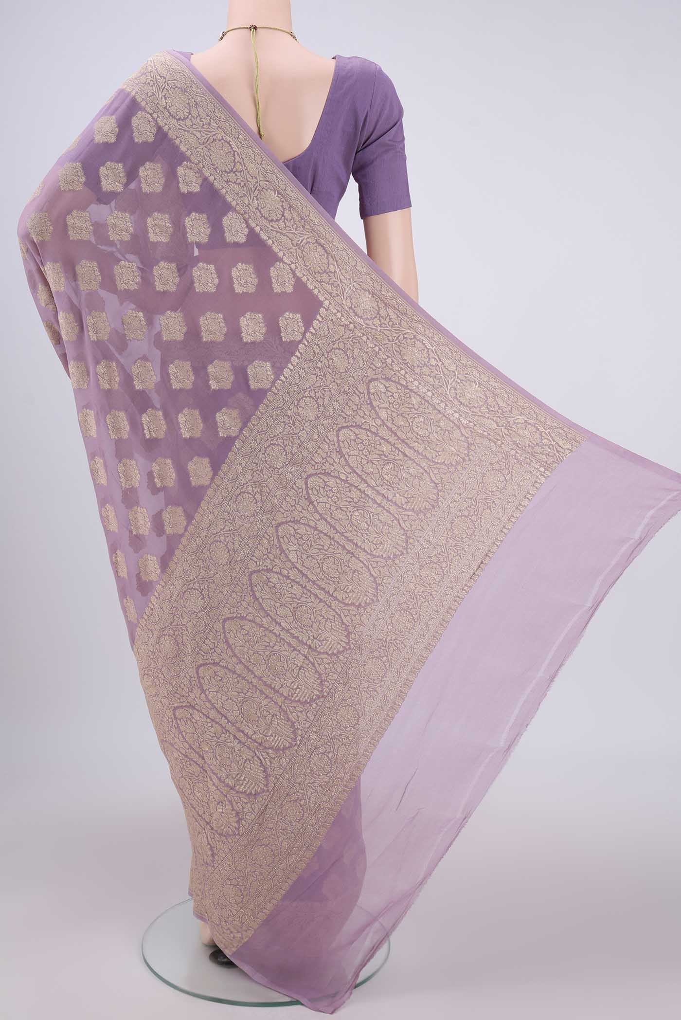 Flat view of Mauve Banarasi Georgette Saree with Zari Butta on the body and Zari Border. 