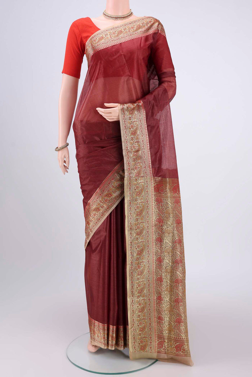 Brown Banarasi Tussar Silk Saree with Zari Butta on the body and Zari And Thread Border.  displayed on a mannequin