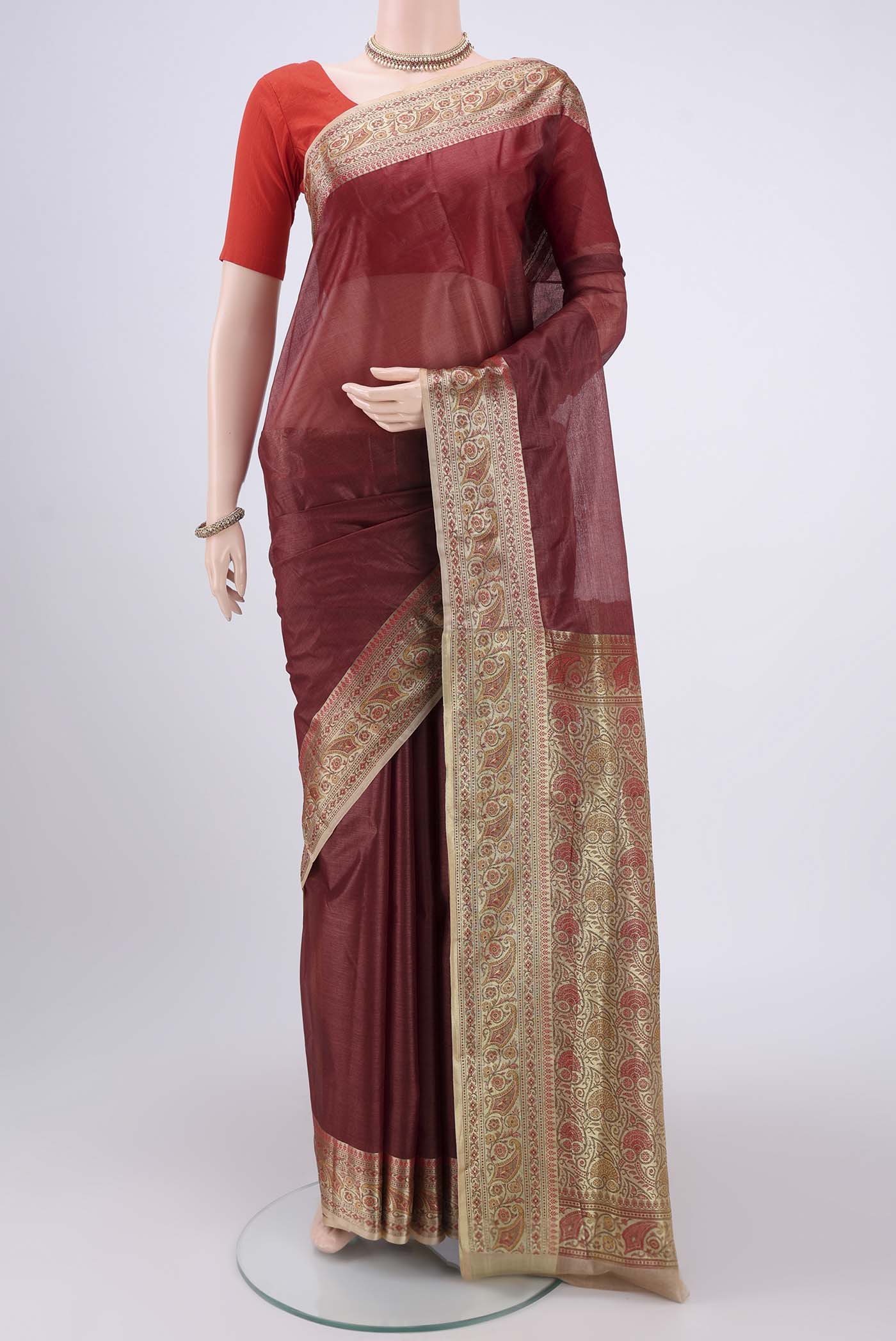 Brown Banarasi Tussar Silk Saree with Zari Butta on the body and Zari And Thread Border.  displayed on a mannequin