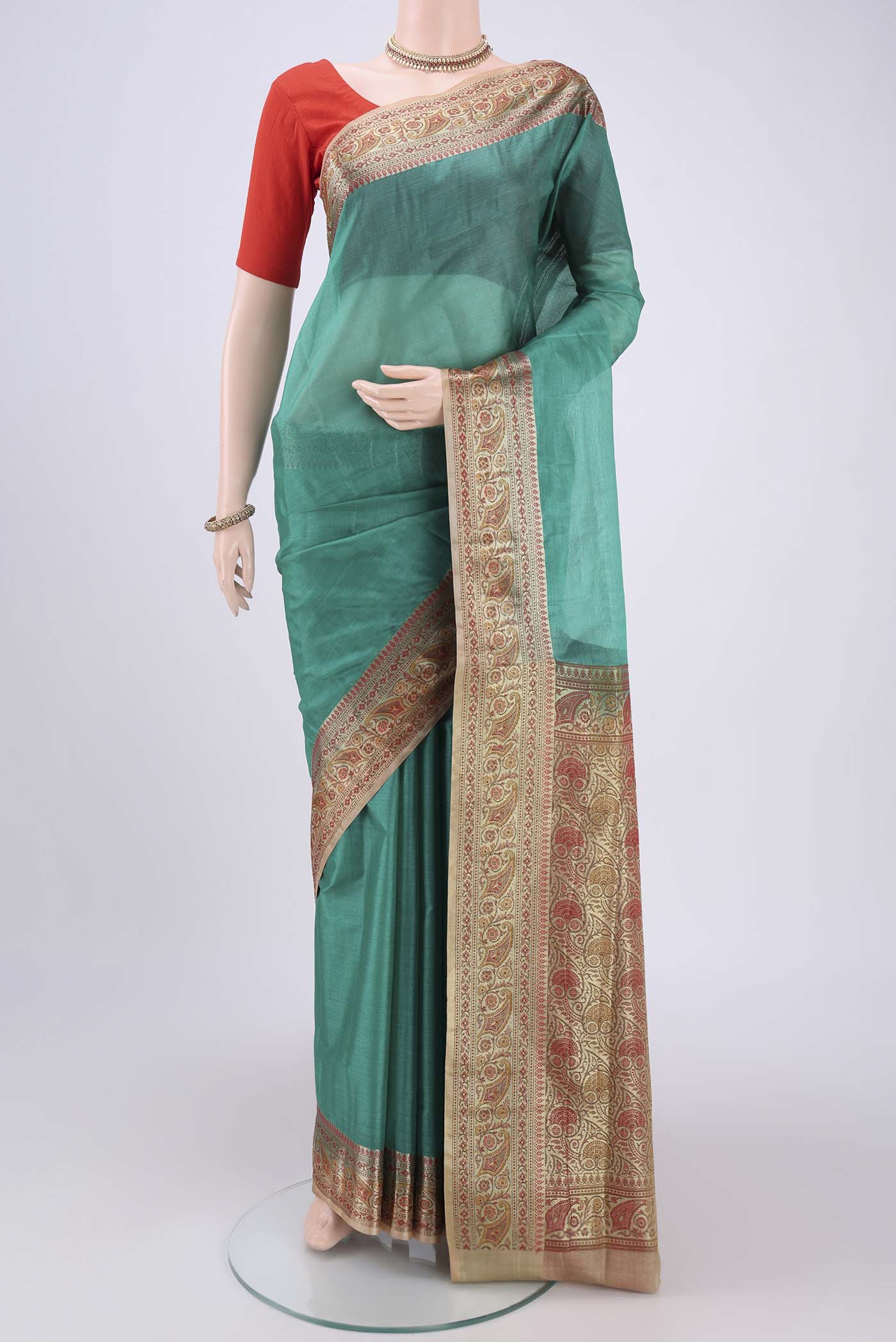 Green Banarasi Tussar Silk Saree with Zari Butta on the body and Zari And Thread Border.  displayed on a mannequin
