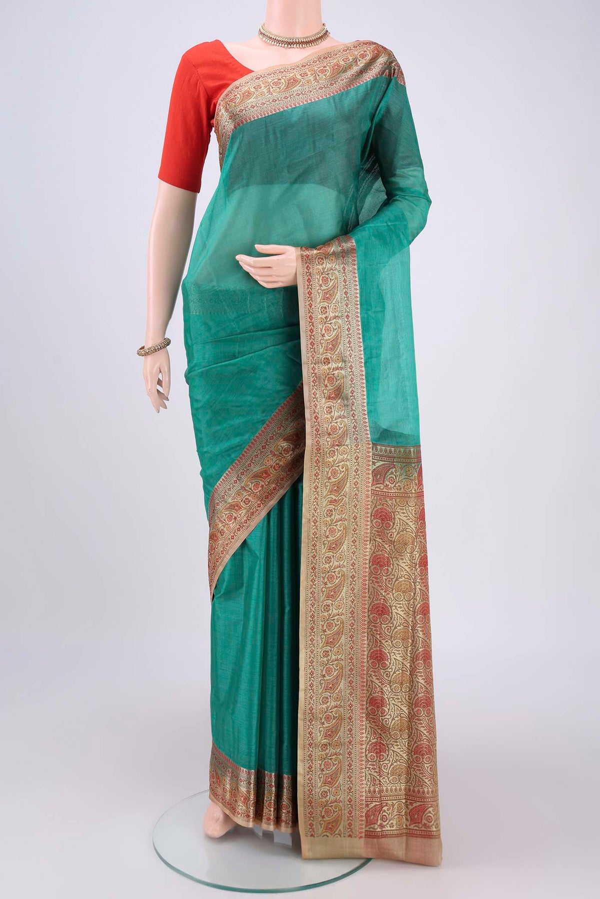 Green Banarasi Tussar Silk Saree with Zari Butta on the body and Zari And Thread Border.  displayed on a mannequin