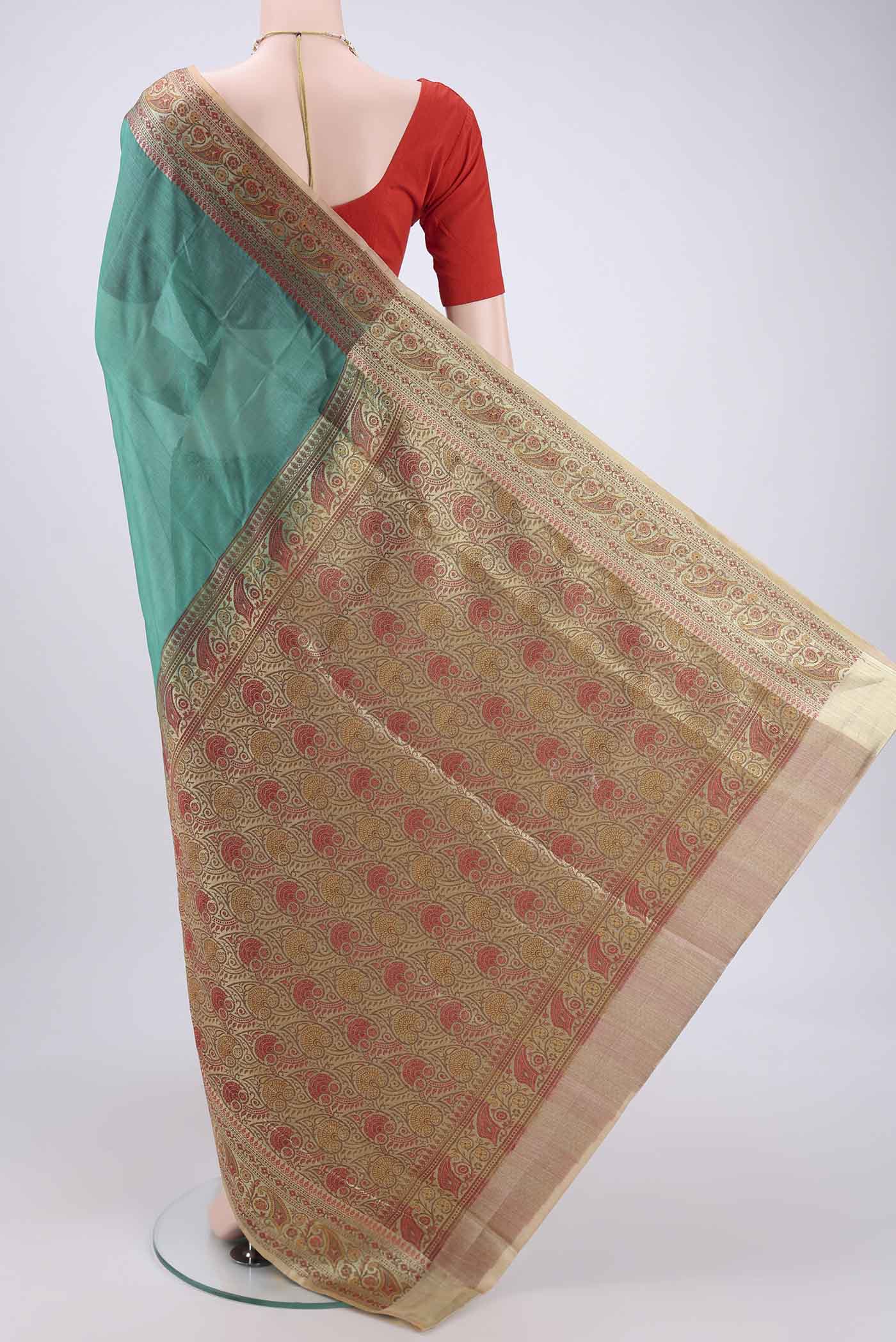 Flat view of Green Banarasi Tussar Silk Saree with Zari Butta on the body and Zari And Thread Border. 