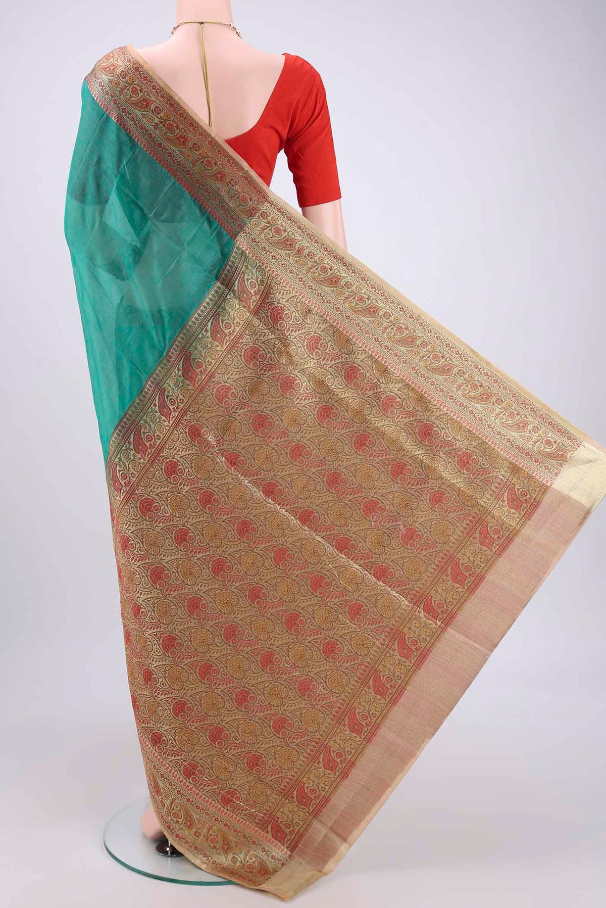 Flat view of Green Banarasi Tussar Silk Saree with Zari Butta on the body and Zari And Thread Border. 