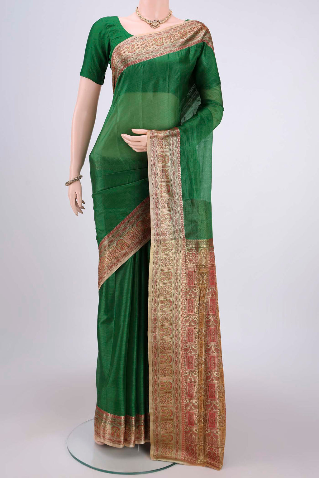 Green Banarasi Tussar Silk Saree with Plain Body and Zari And Thread Border.  displayed on a mannequin