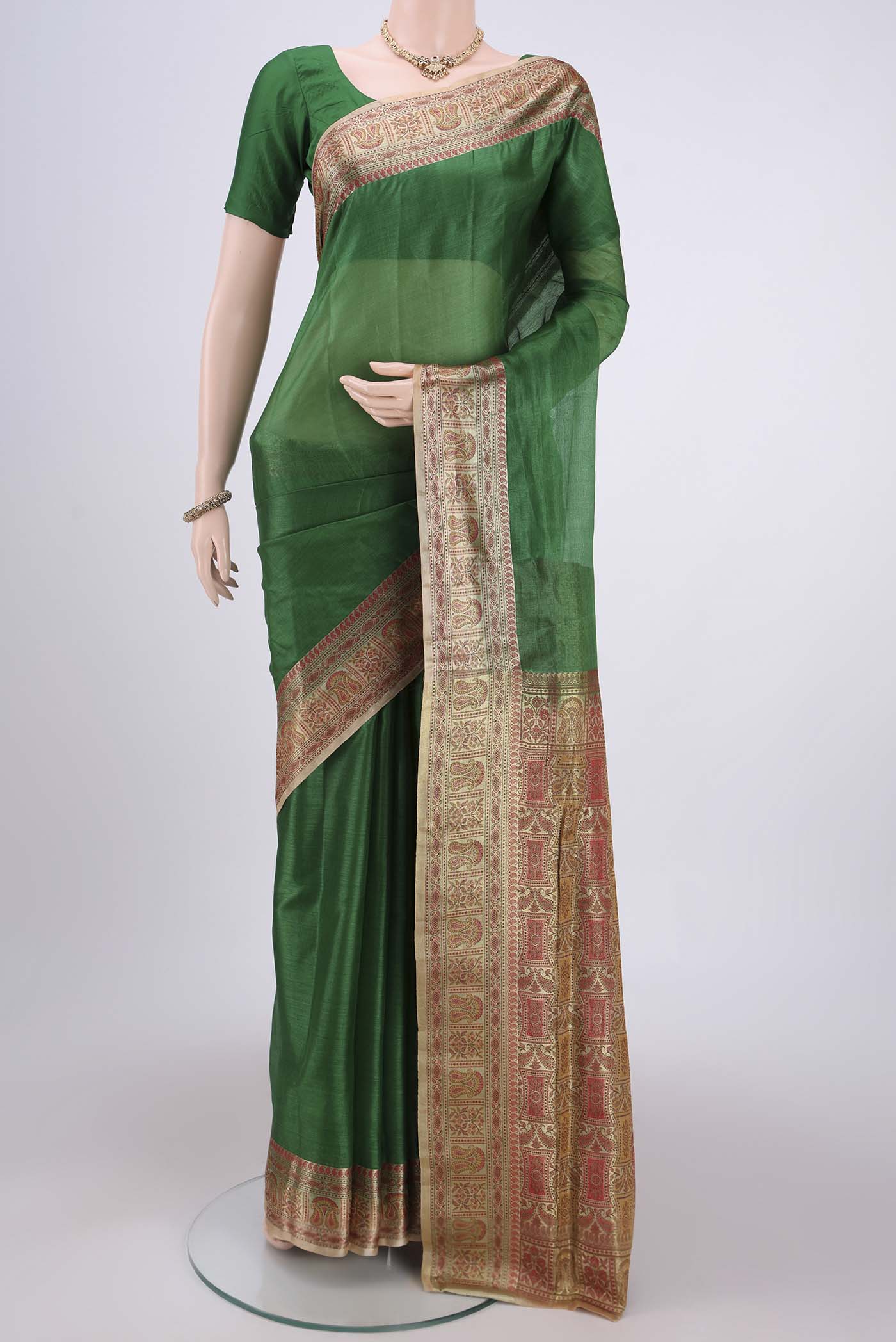 Green Banarasi Tussar Silk Saree with Plain Body and Zari And Thread Border.  displayed on a mannequin