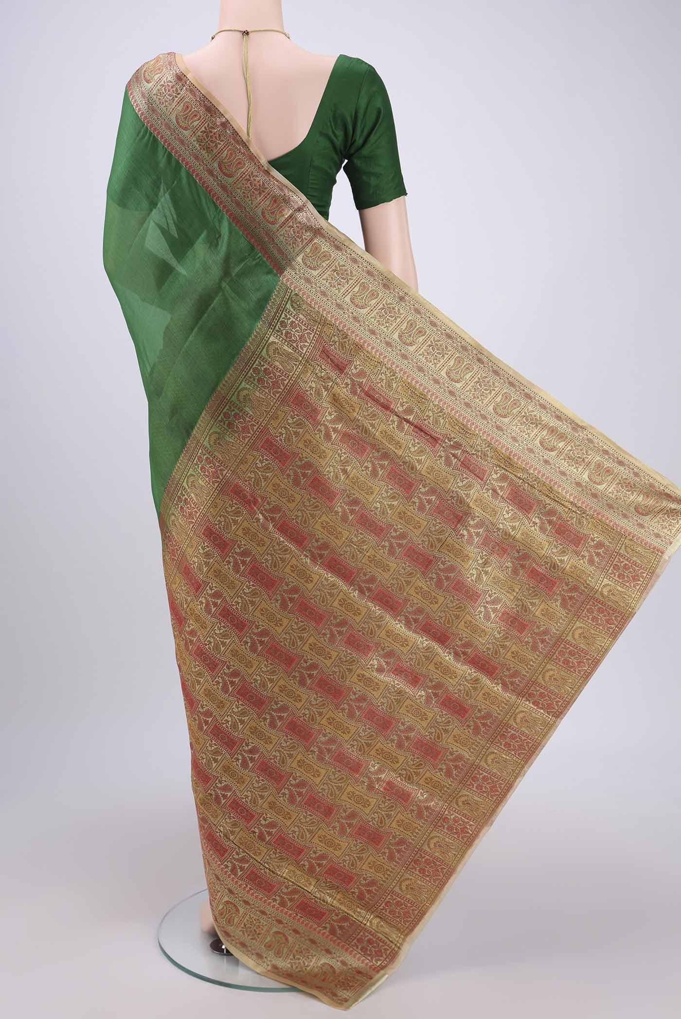 Flat view of Green Banarasi Tussar Silk Saree with Plain Body and Zari And Thread Border. 