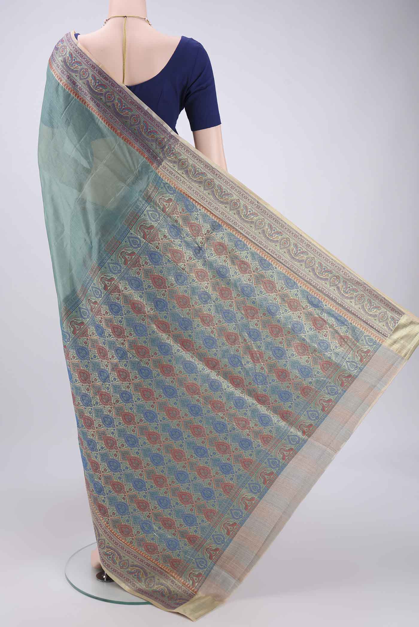 Flat view of Sea Green Banarasi Tussar Silk Saree with Zari Butta on the body and Zari And Thread Border. 