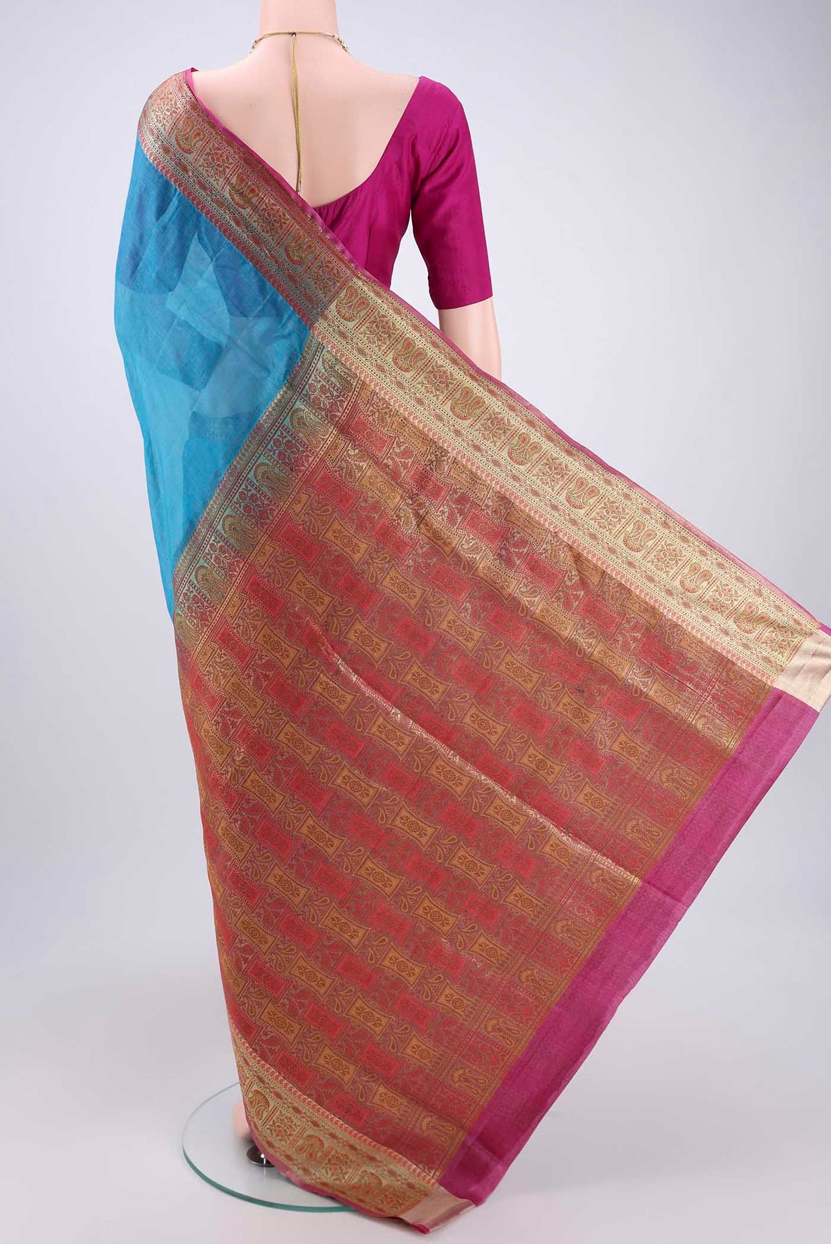 Flat view of Blue Banarasi Tussar Silk Saree with Zari Butta on the body and Zari And Thread Border. 