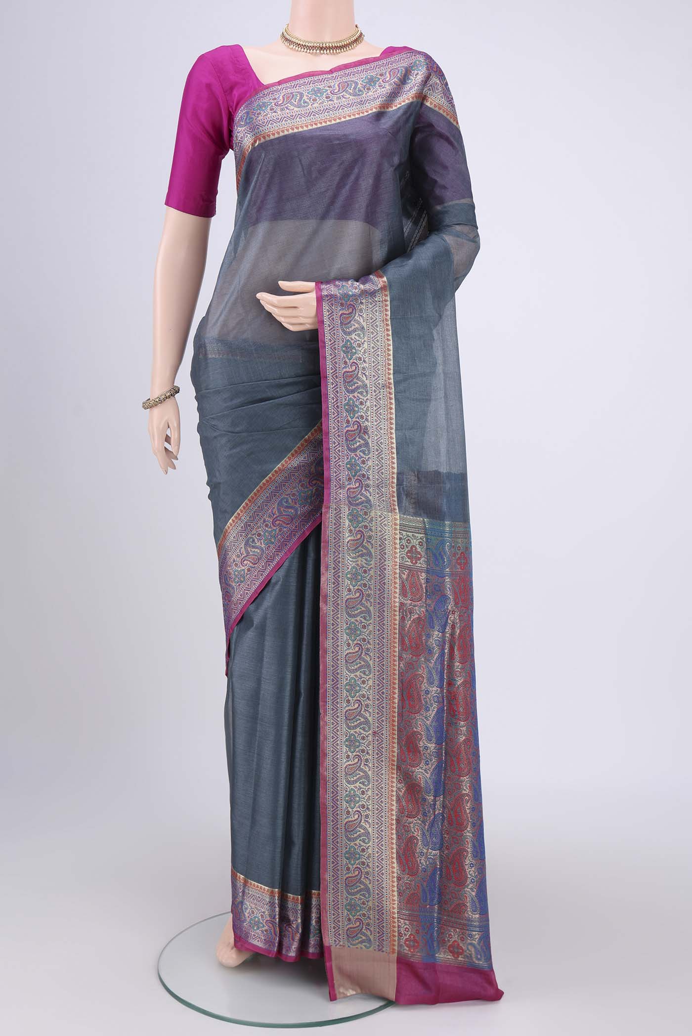 Grey Banarasi Tussar Silk Saree with Zari Butta on the body and Zari And Thread Border.  displayed on a mannequin