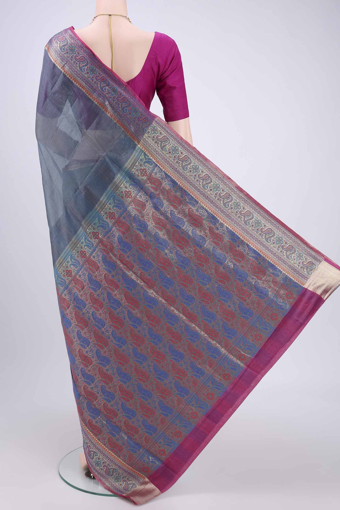 Flat view of Grey Banarasi Tussar Silk Saree with Zari Butta on the body and Zari And Thread Border. 