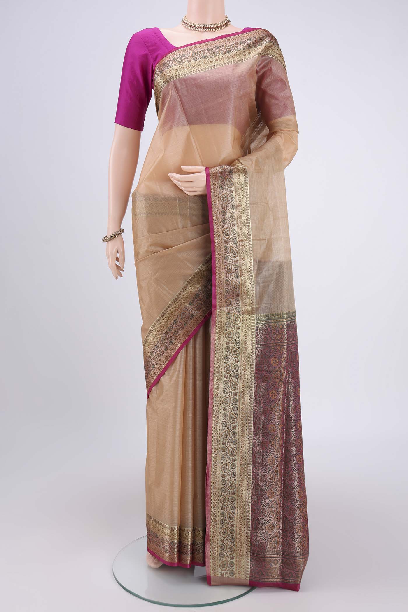 Beige Banarasi Tussar Silk Saree with Zari Butta on the body and Zari And Thread Border.  displayed on a mannequin