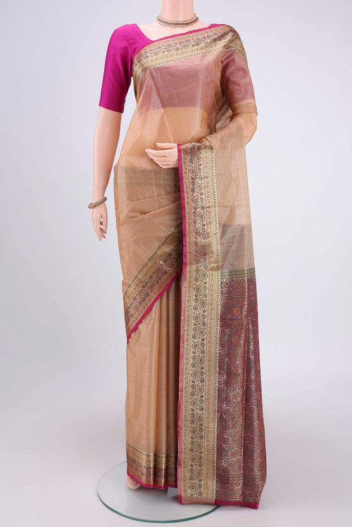 Beige Banarasi Tussar Silk Saree with Zari Butta on the body and Zari And Thread Border.  displayed on a mannequin