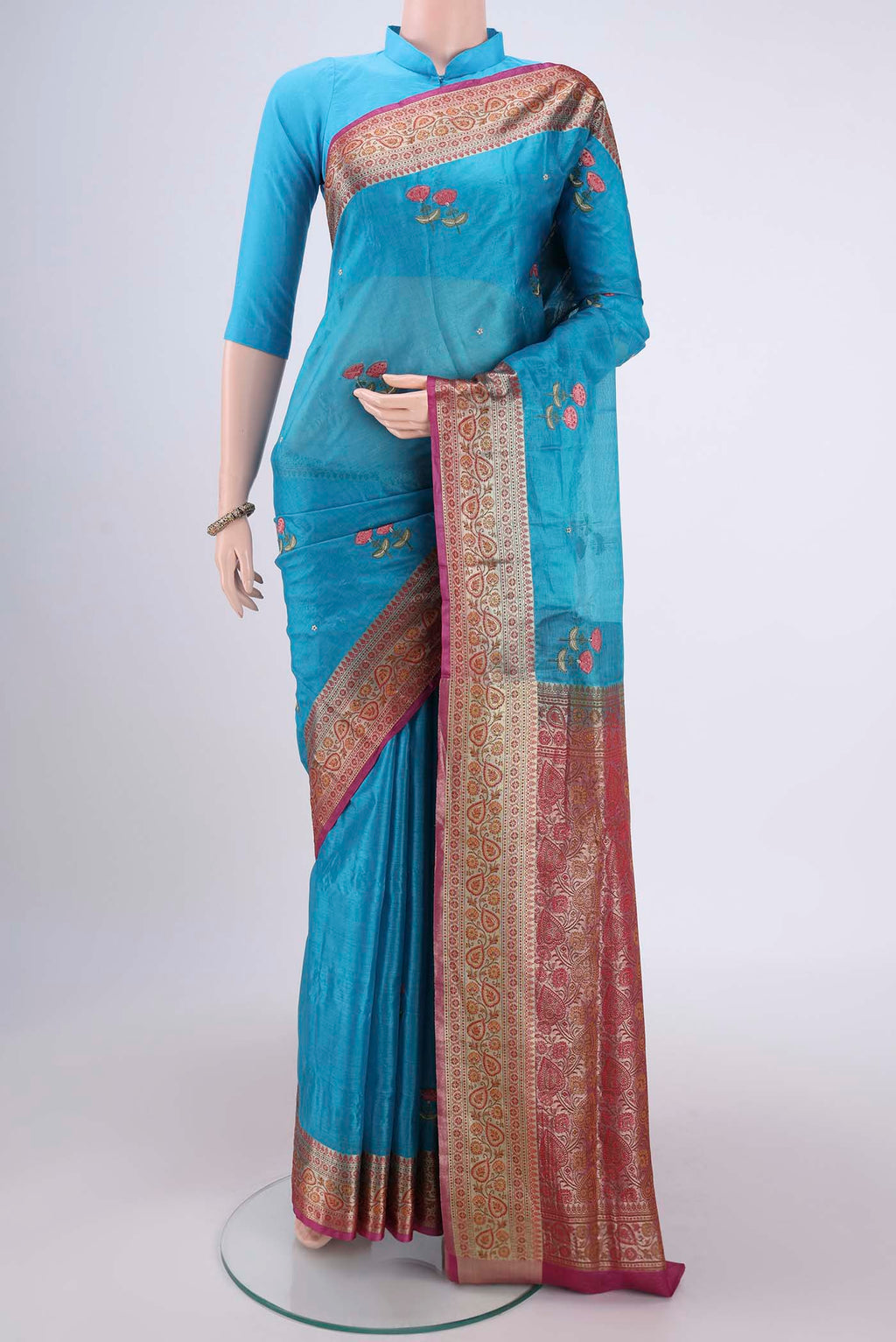 Blue Banarasi Tussar Silk Saree with Embroidery on the body and Zari And Thread Border.  displayed on a mannequin
