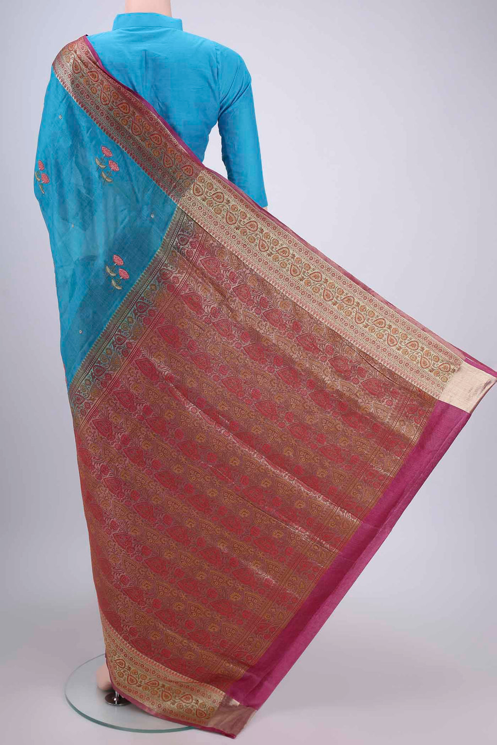 Flat view of Blue Banarasi Tussar Silk Saree with Embroidery on the body and Zari And Thread Border. 